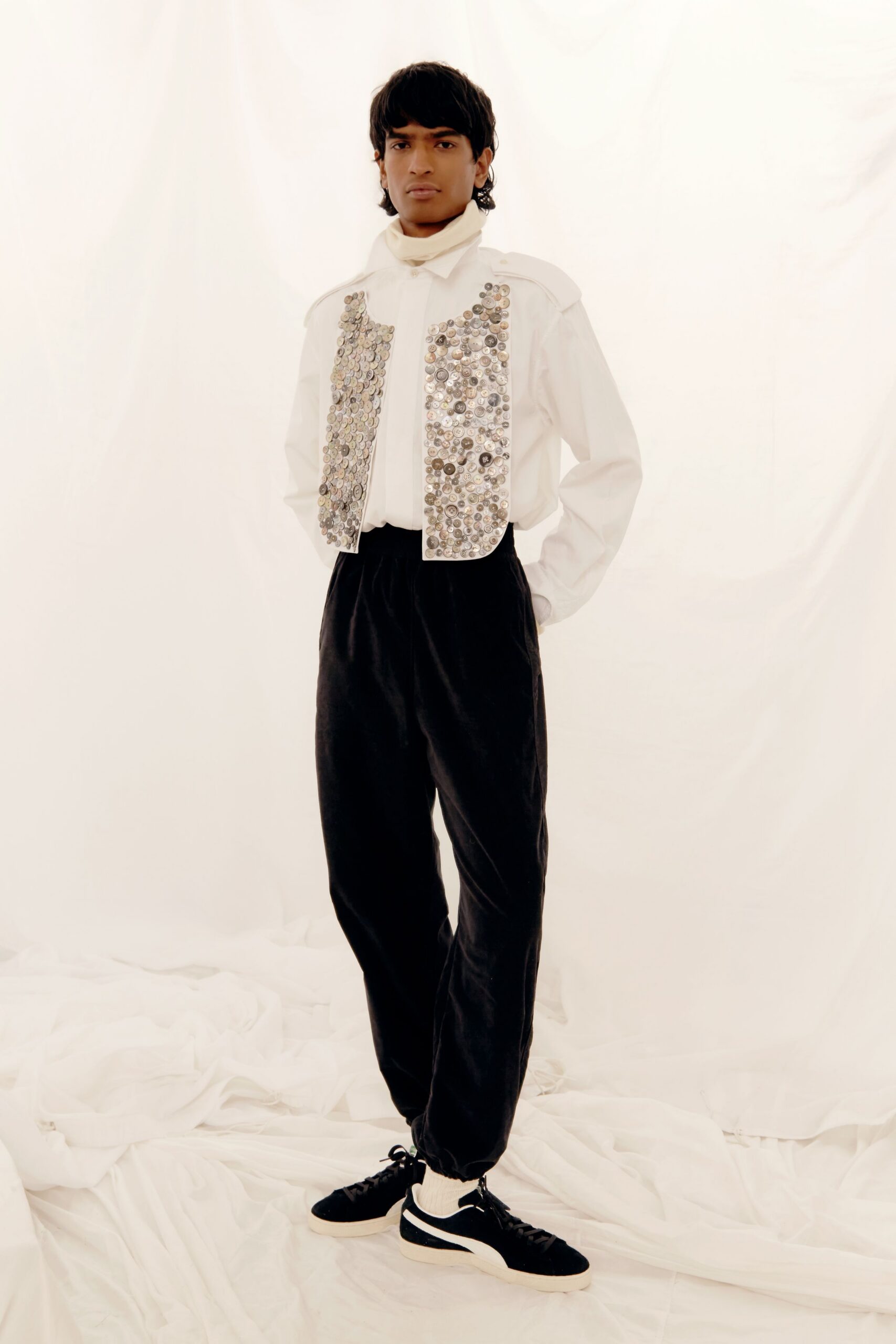 white beaded vest with black pants