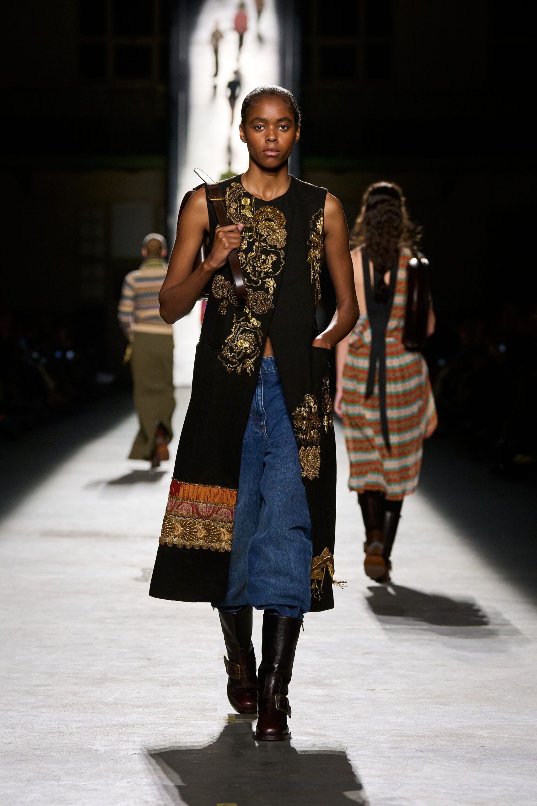 black embroidered vest with denim pants
