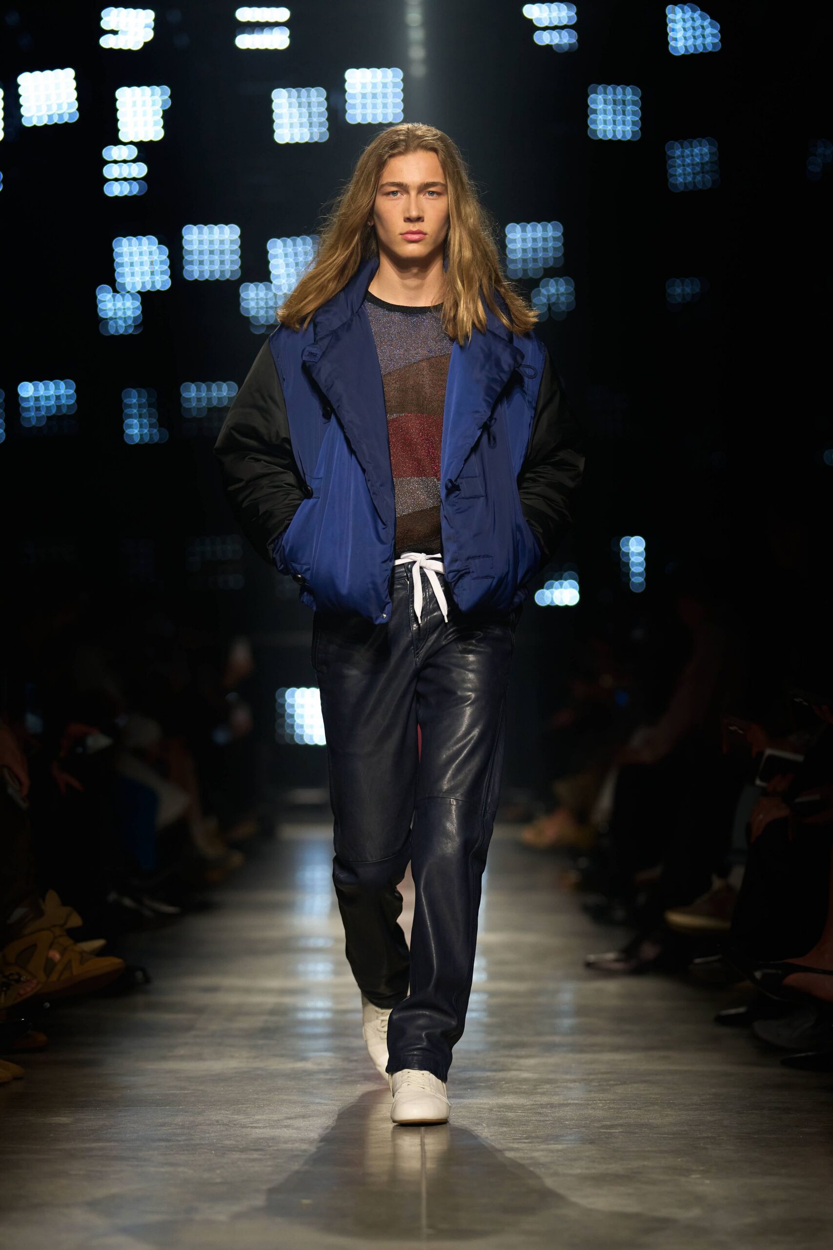 blue jacket multi top black pants white shoes