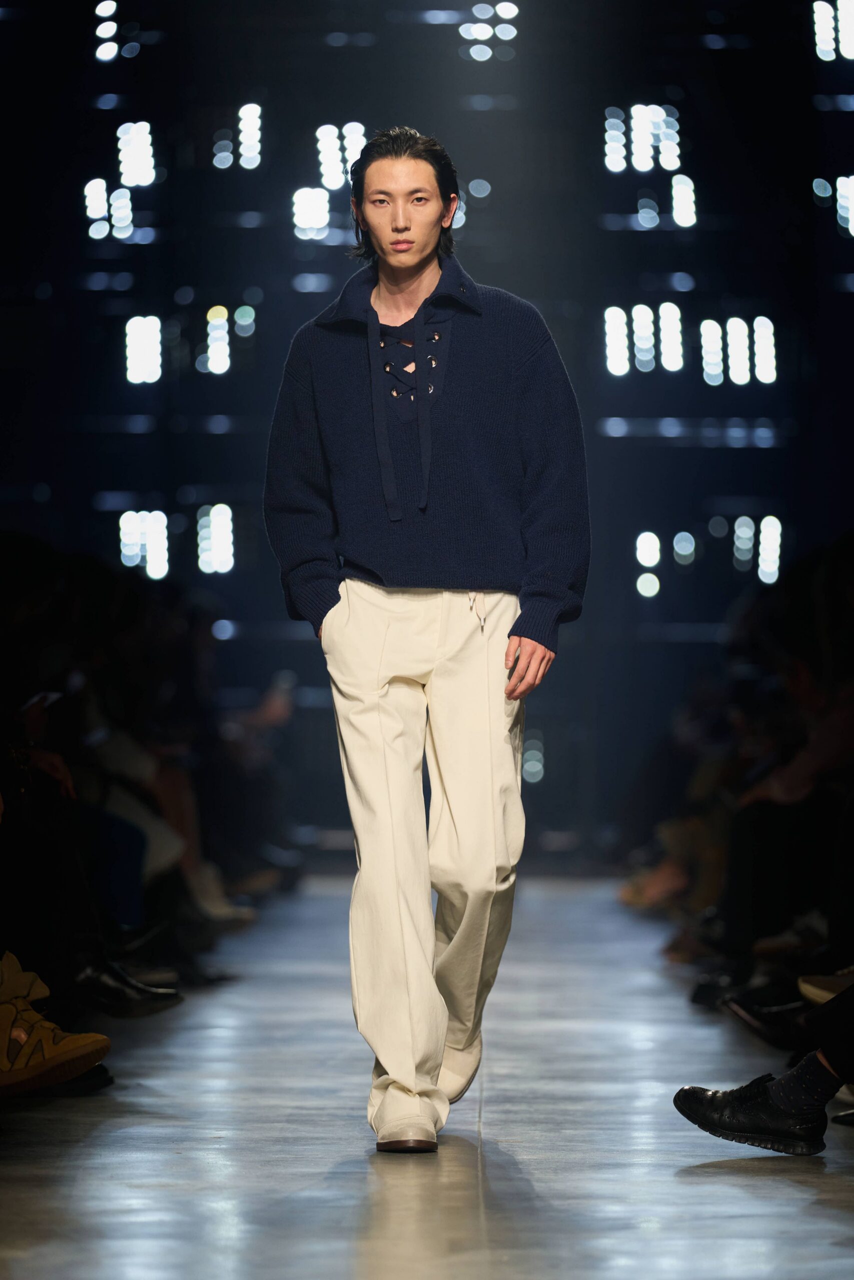 navy relaxed sweater and white tailored pants