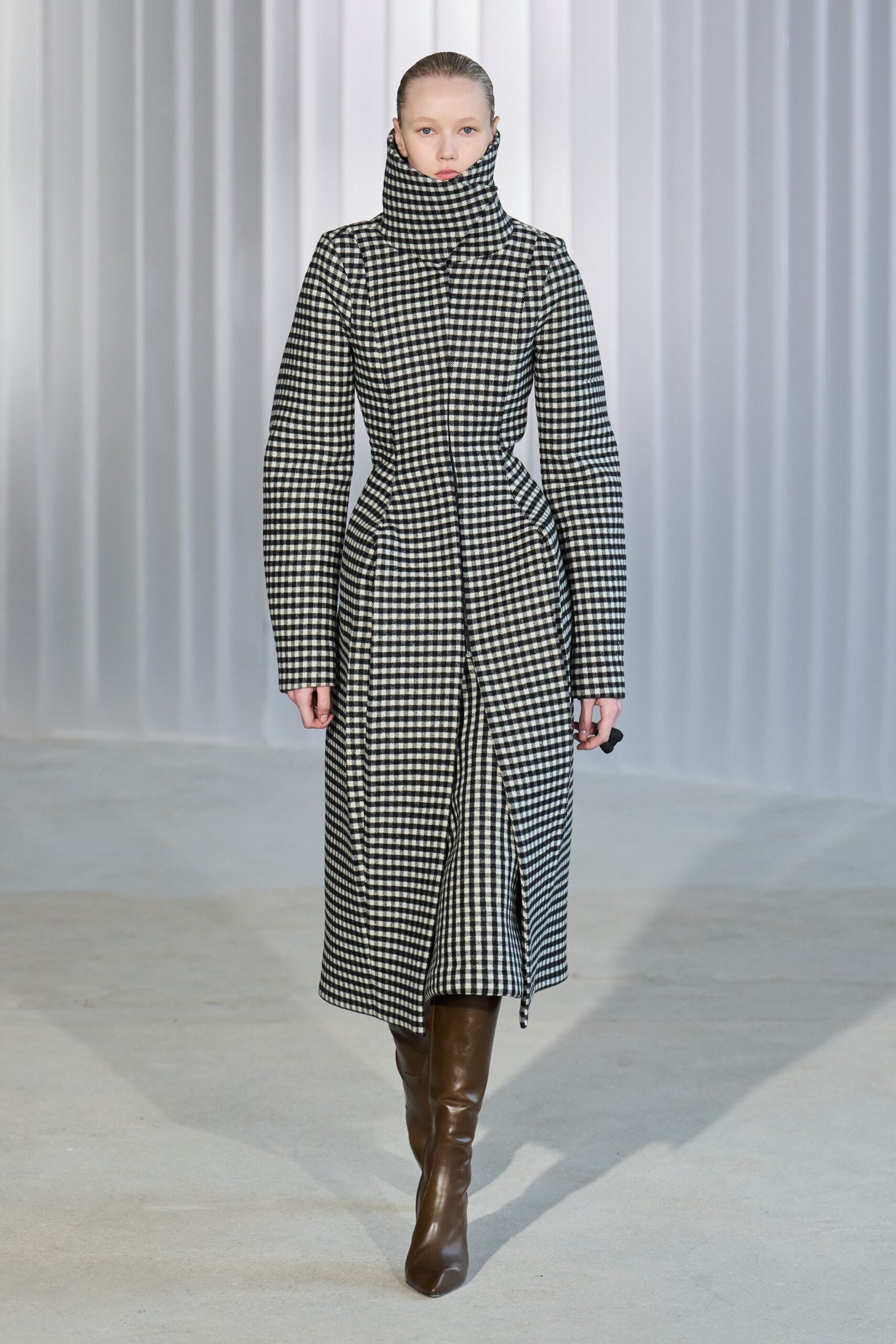 checked midi coat with brown boots