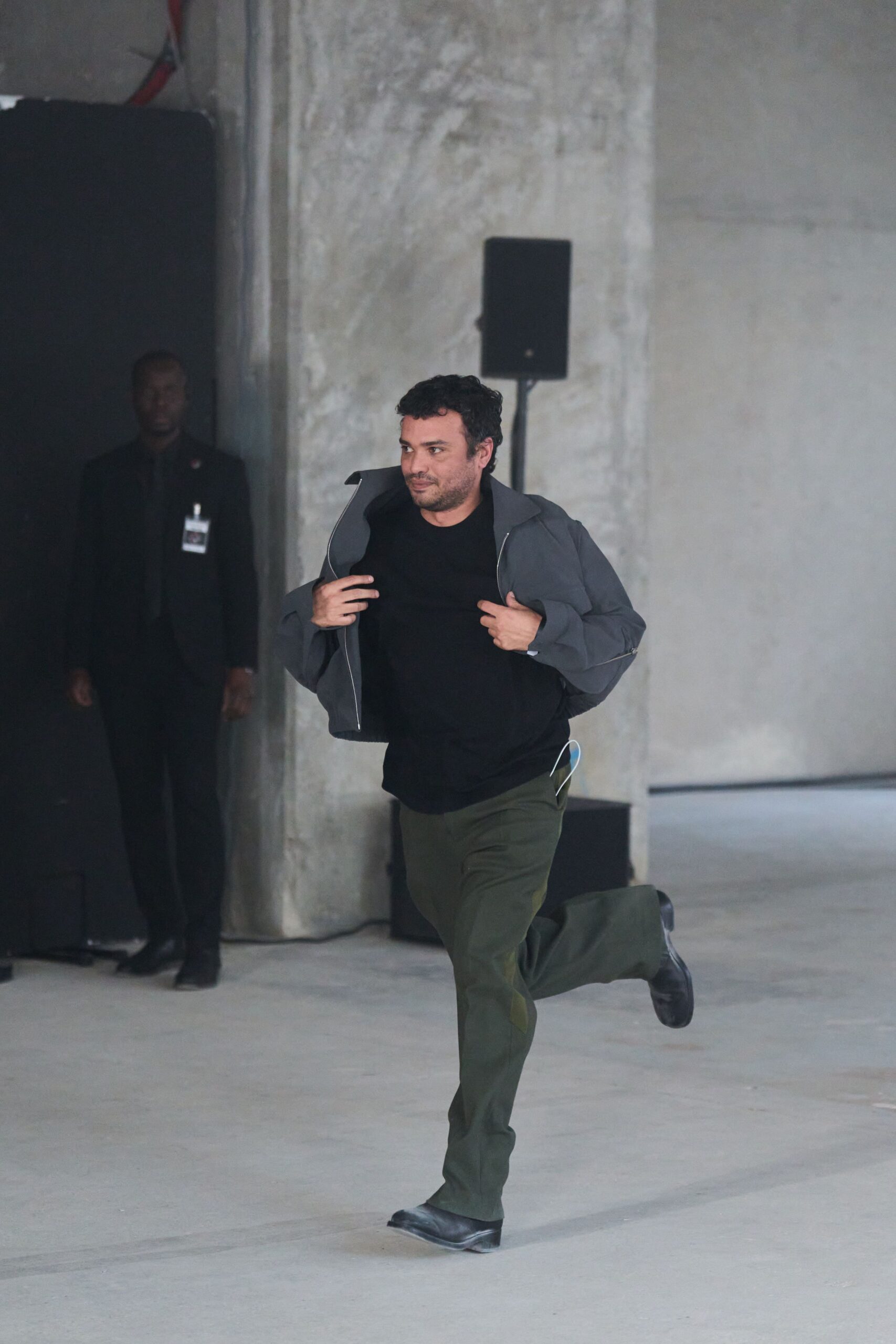gray jacket black t-shirt green pants
