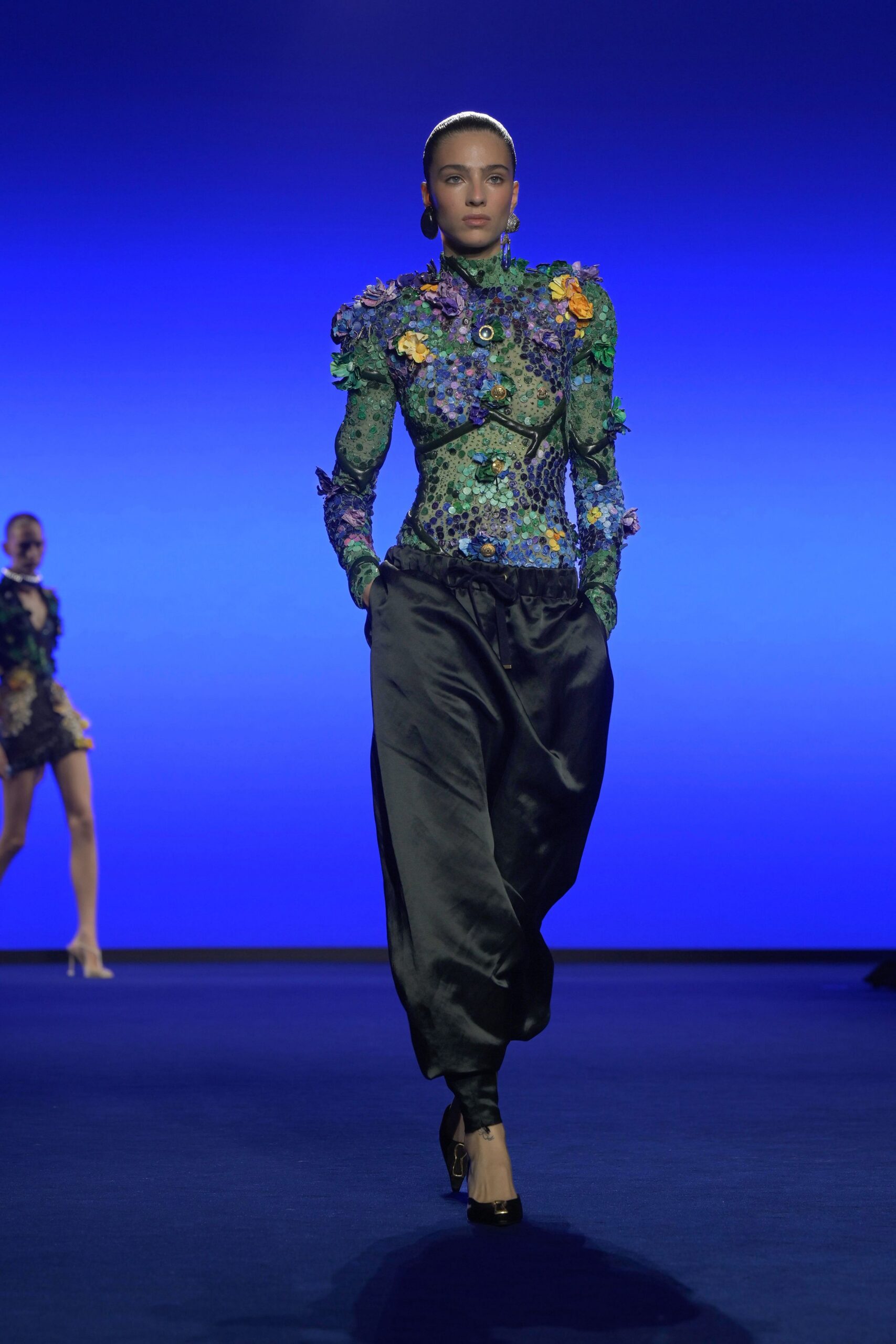 fitted green embroidered top with relaxed black pants