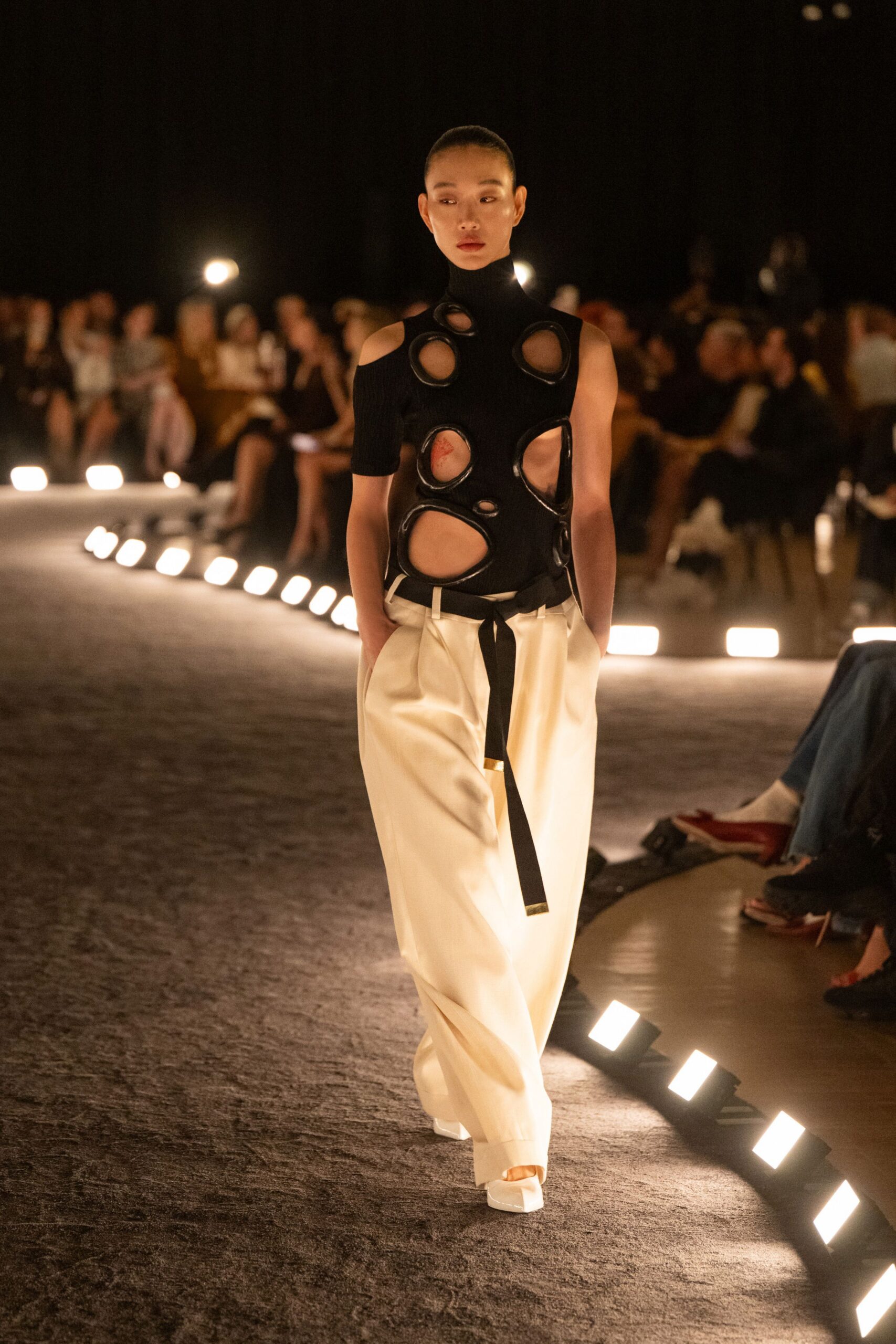 black cutout top with white pants
