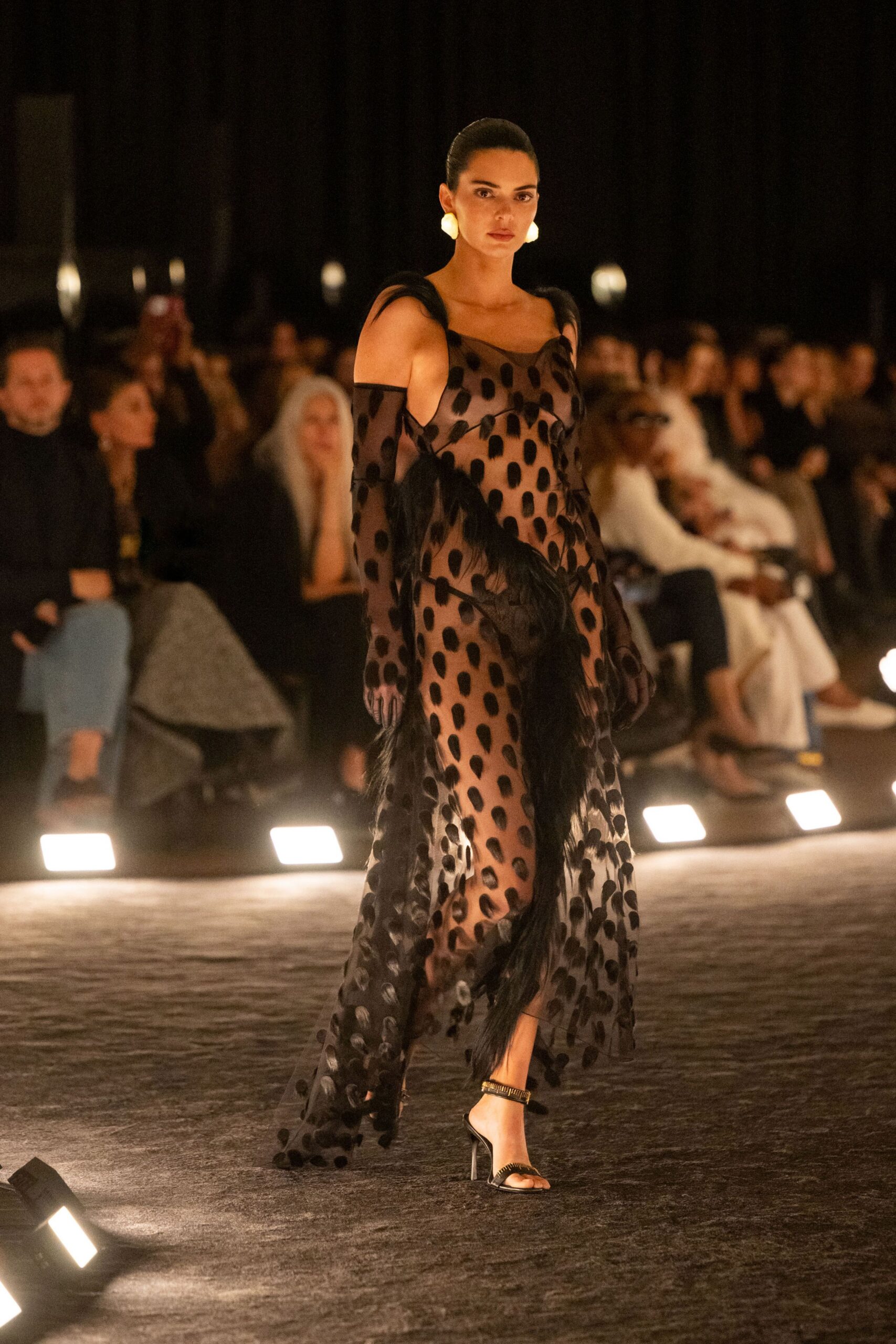 black sheer polka-dot gown with strappy shoes