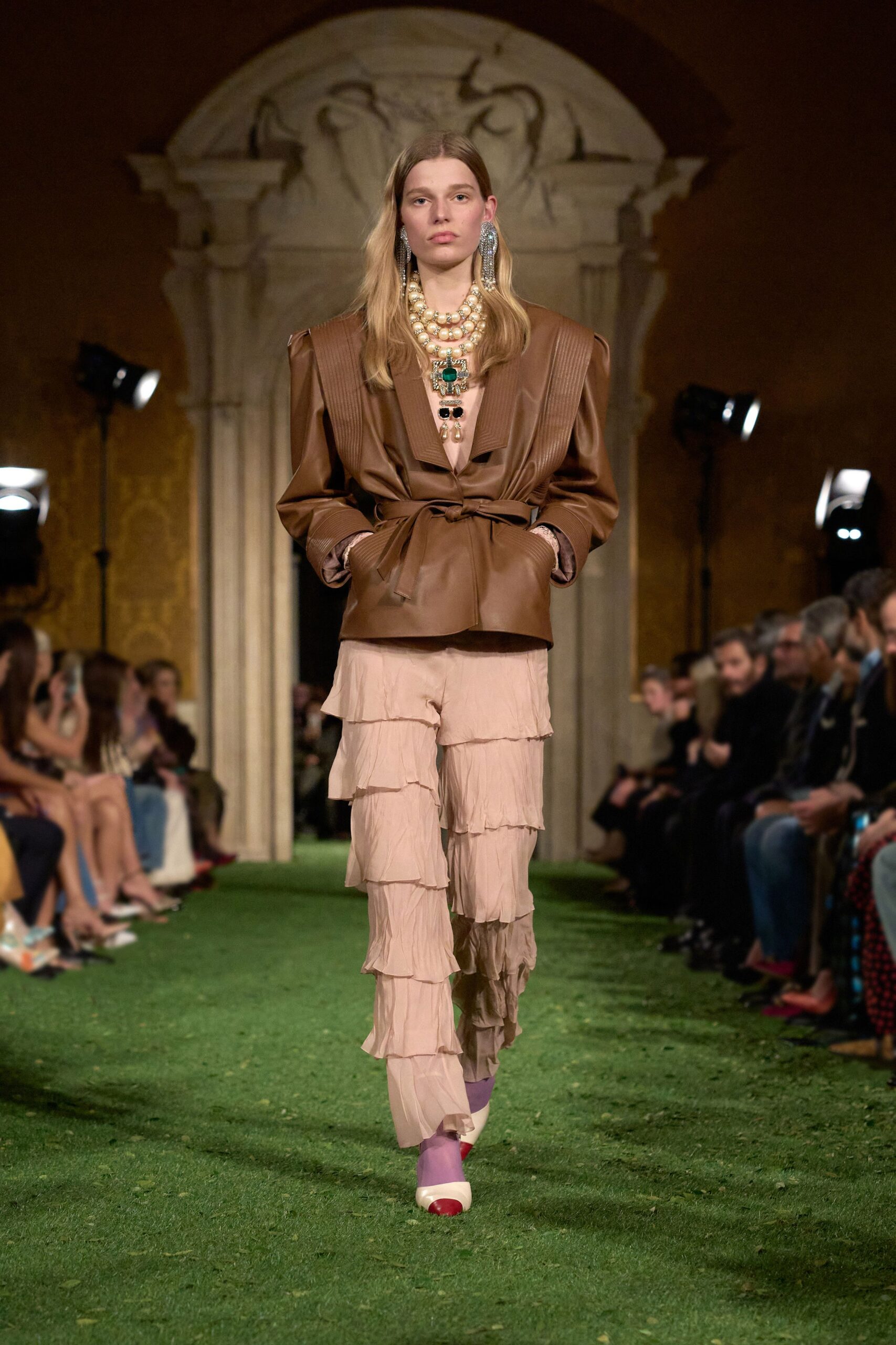 brown leather structured blazer with pink tiered pants