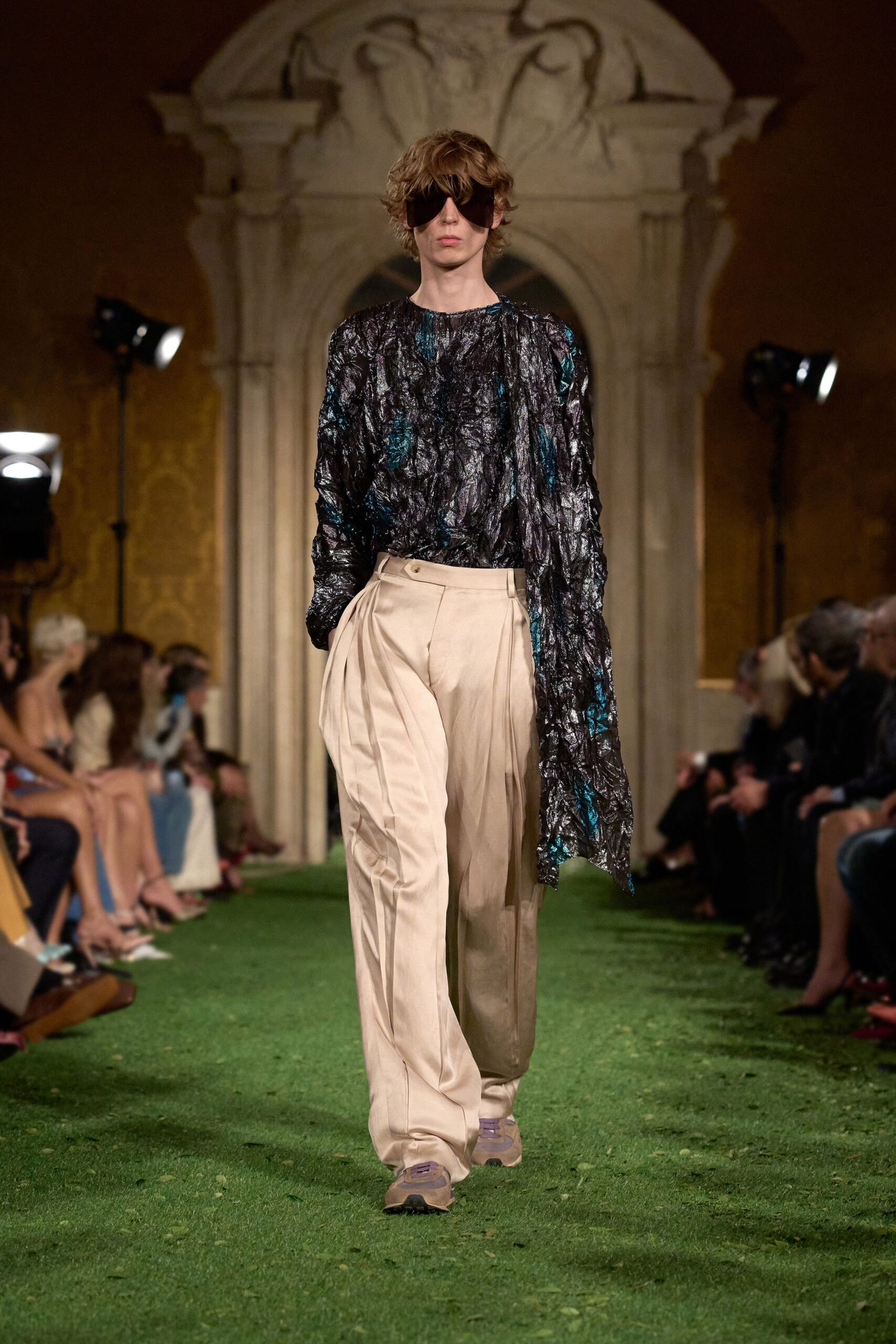 asymmetric black silk top with beige pants