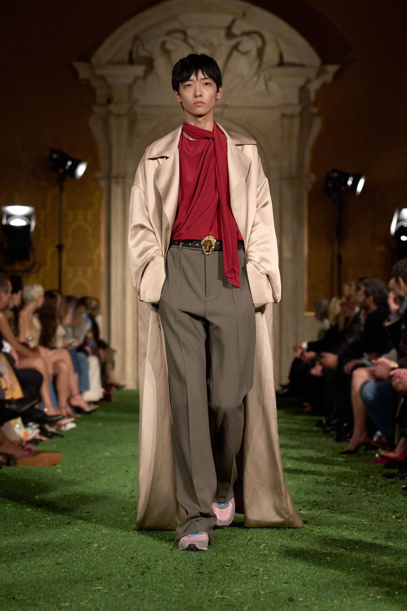 beige coat red top gray pants