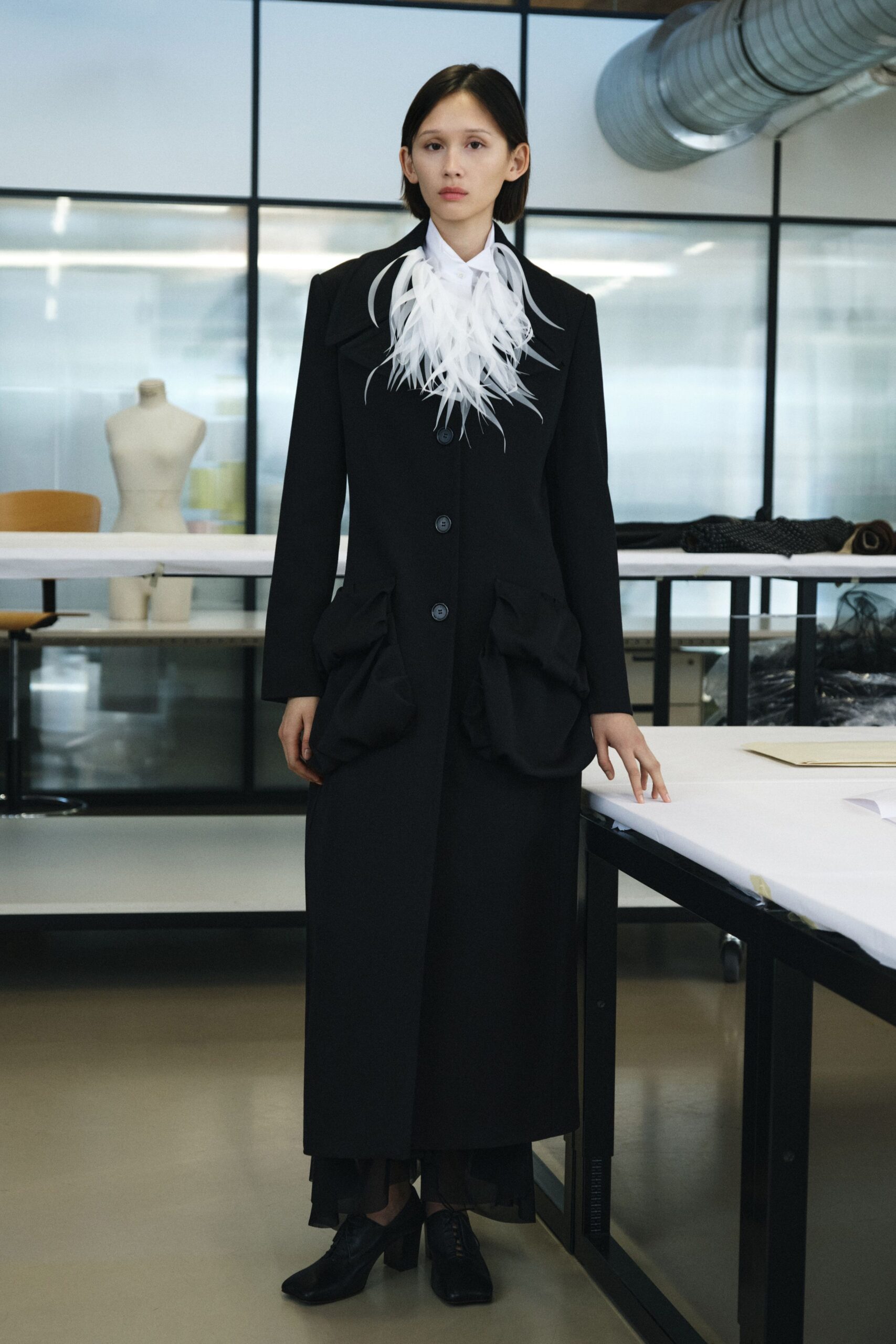 black wool long-sleeve collared relaxed buttoned pockets coat