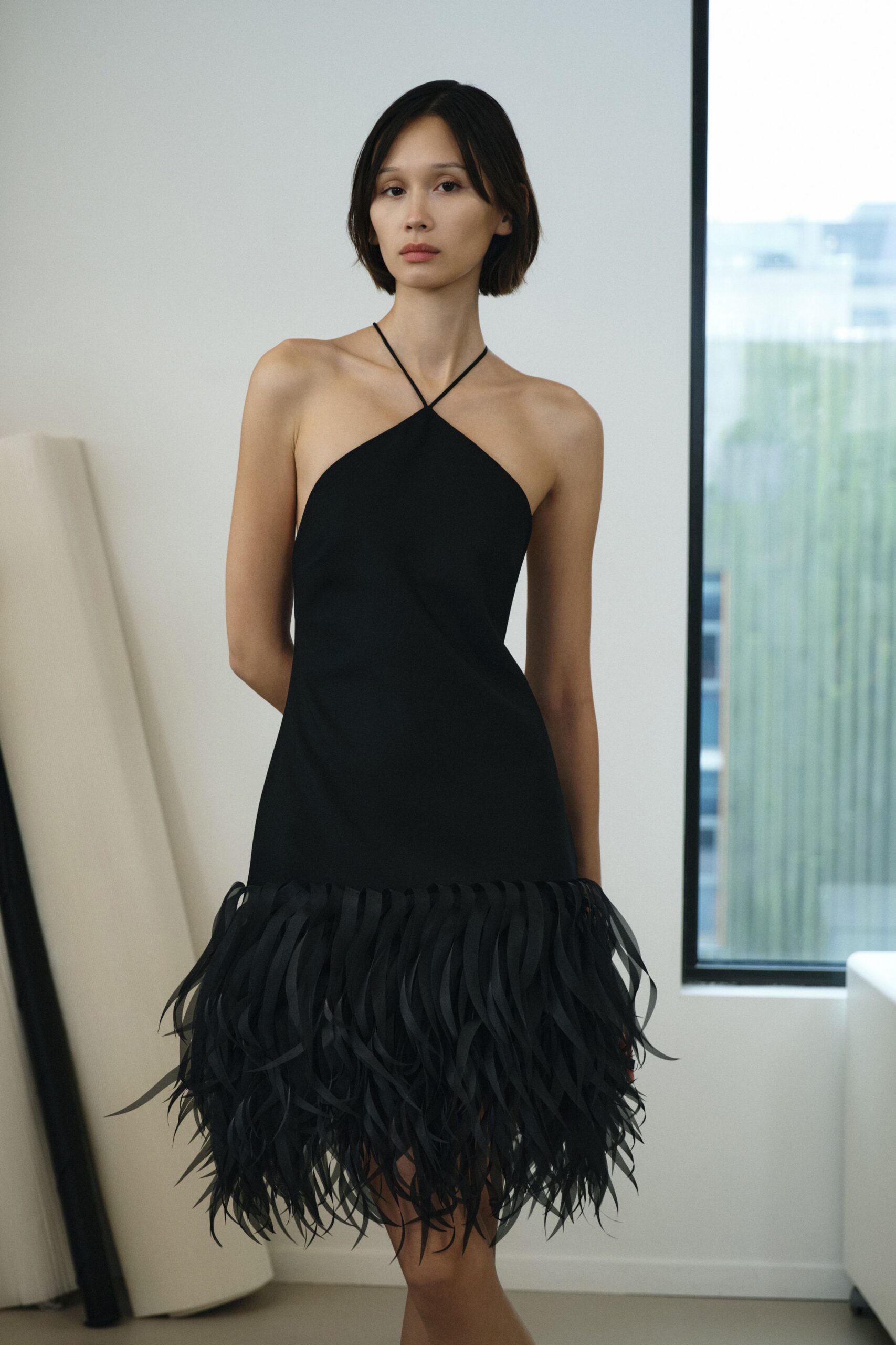 black sleeveless fringed dress