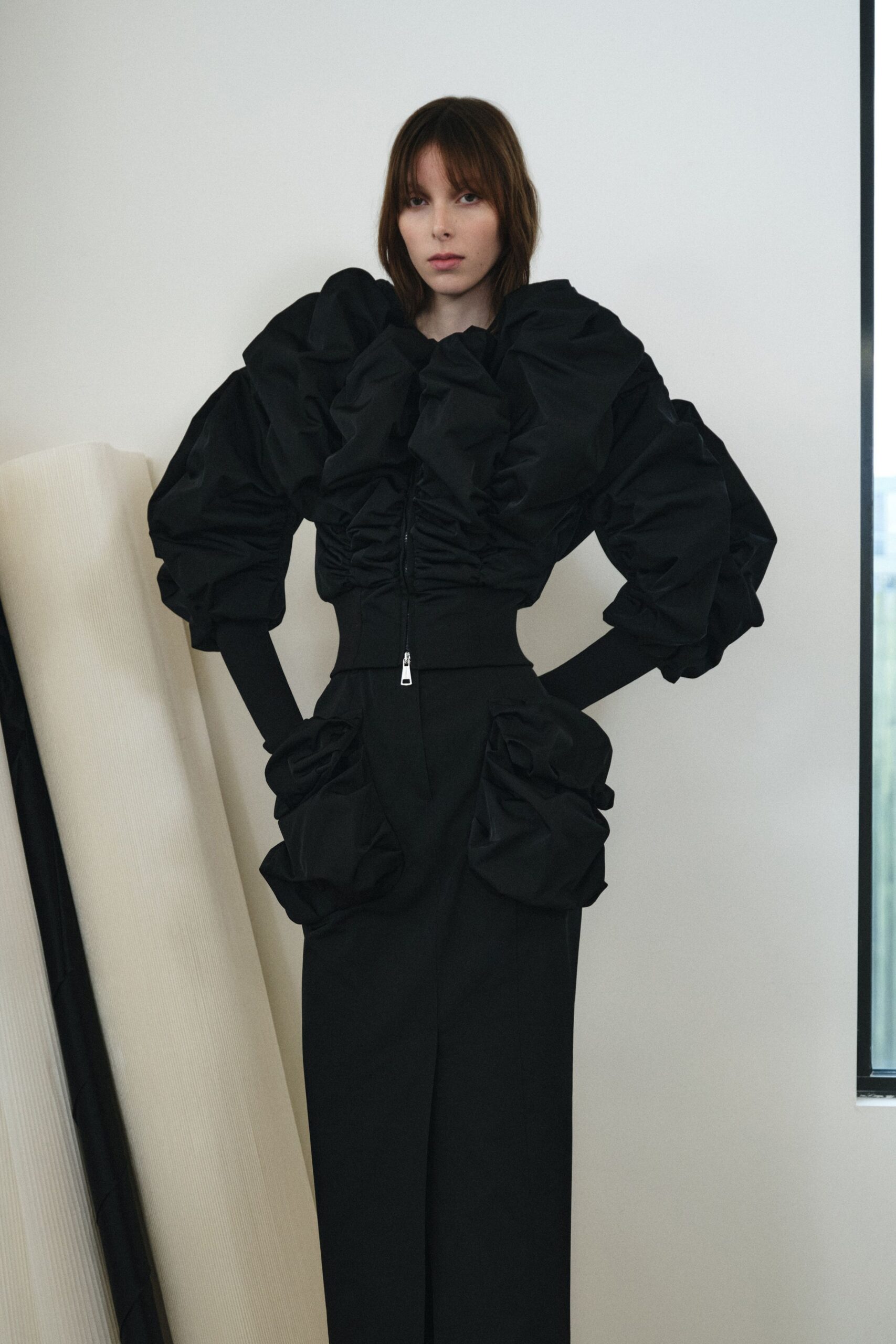 black ruffled top and fitted pants