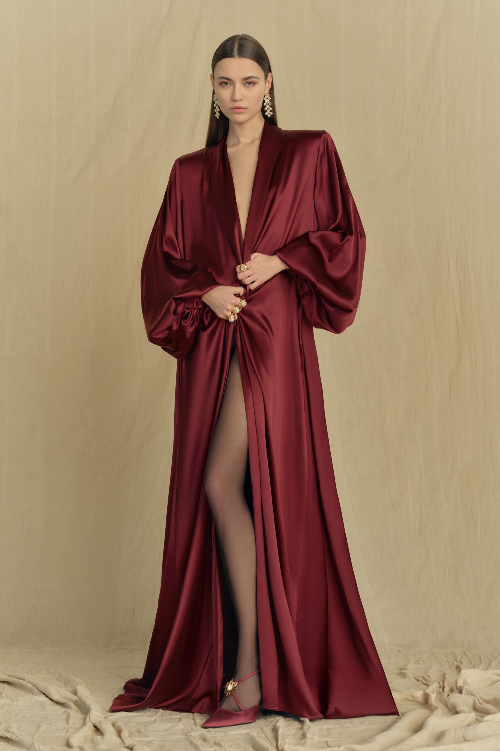 red silk long-sleeve v-neck fitted draped flowing gown