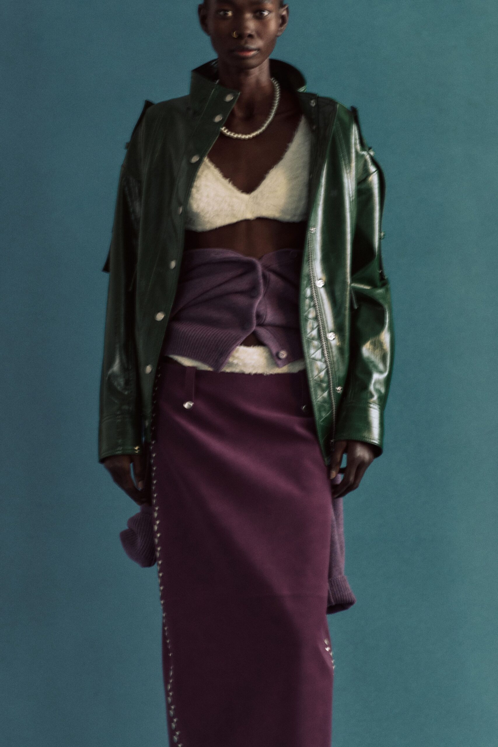 green leather jacket with purple skirt