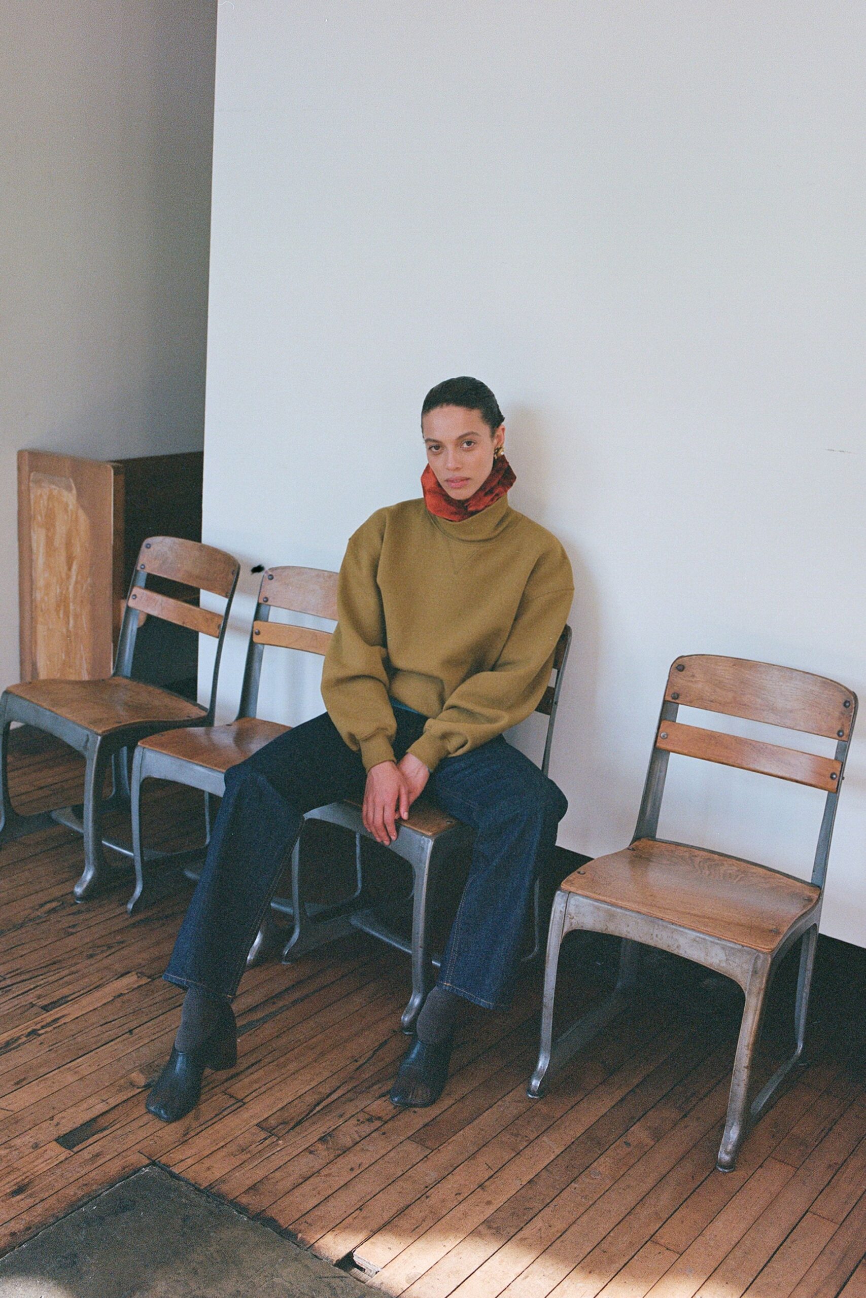 green relaxed sweater with denim pants