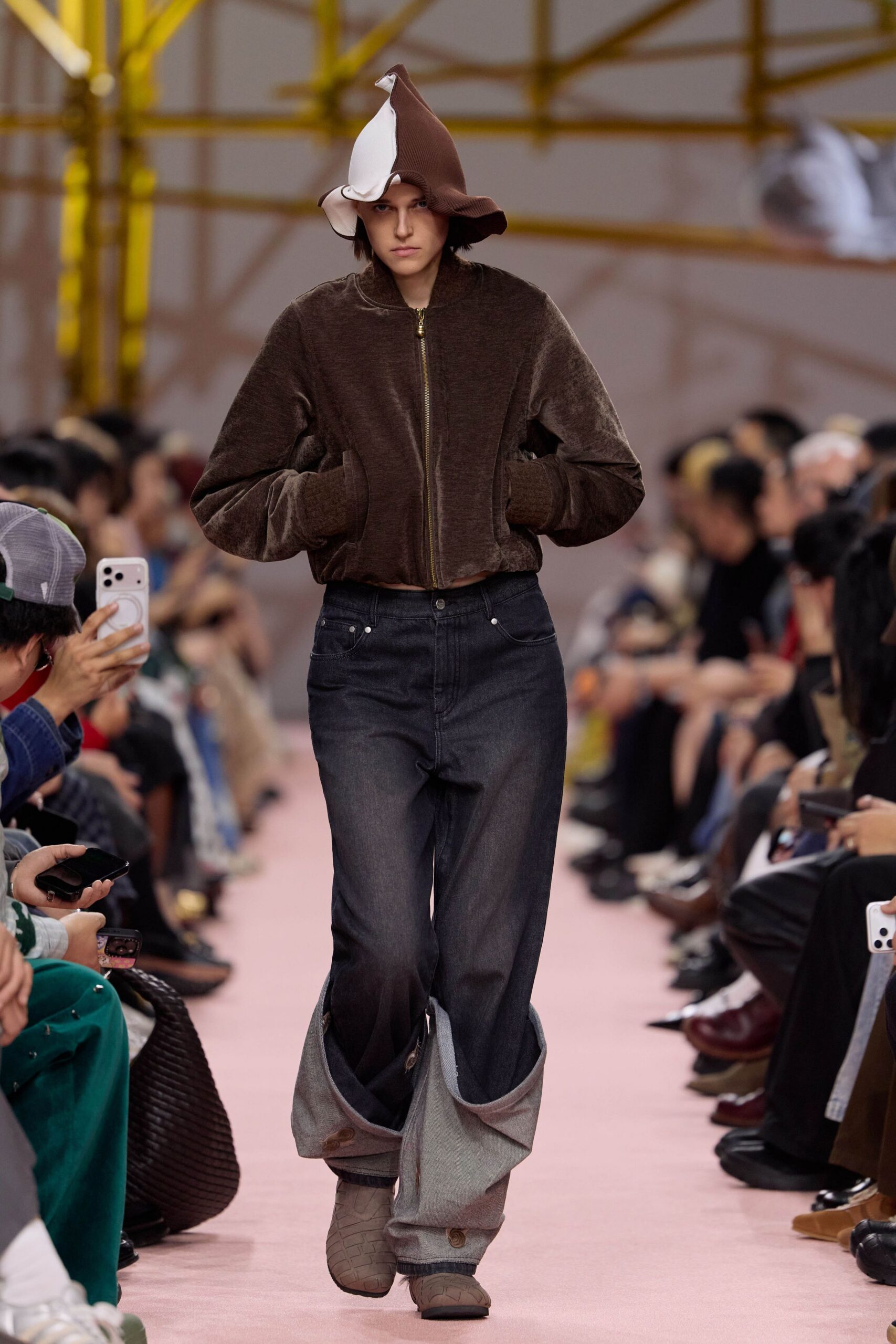 brown faux-fur hooded jacket with distressed denim pants