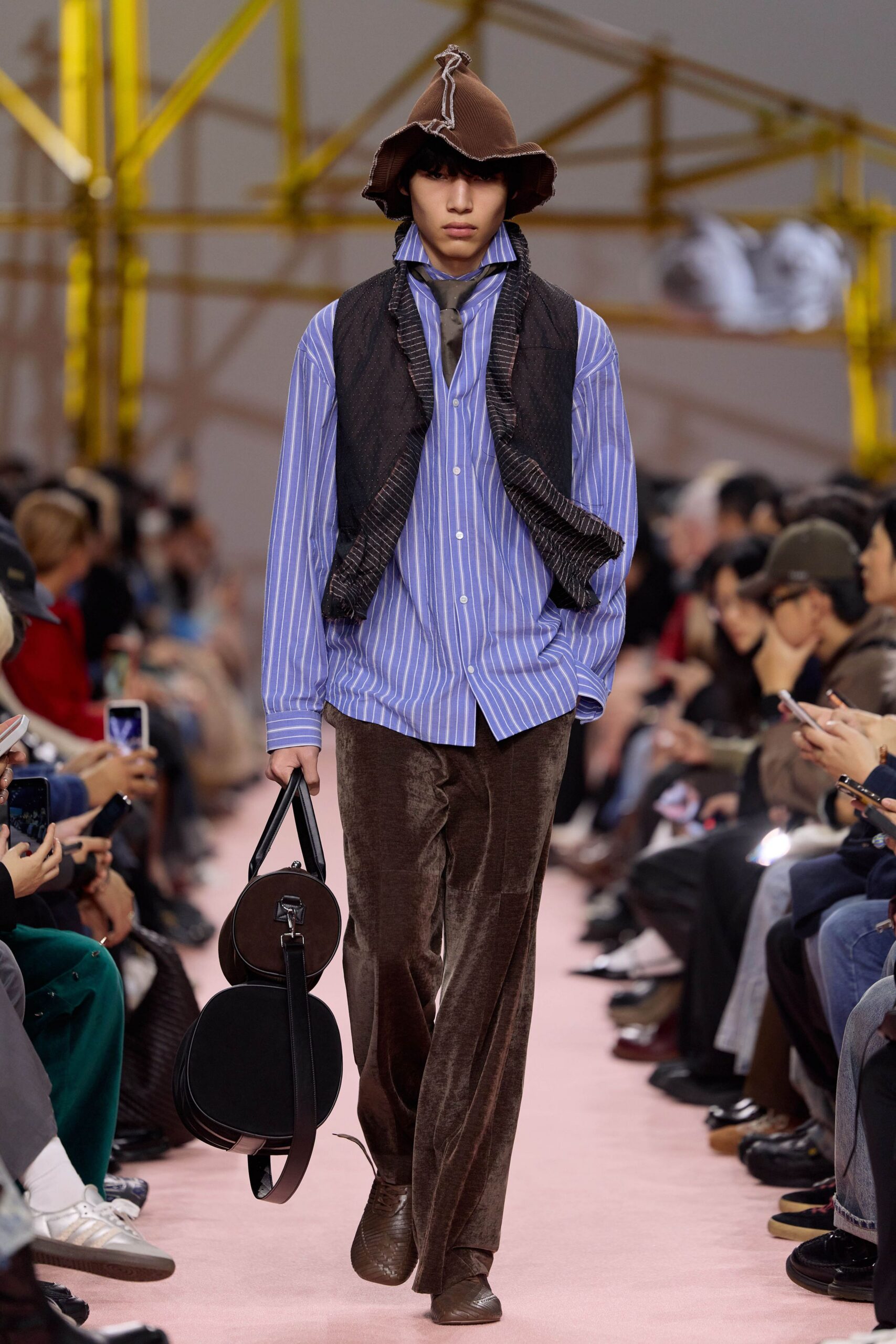 blue striped shirt and brown pants