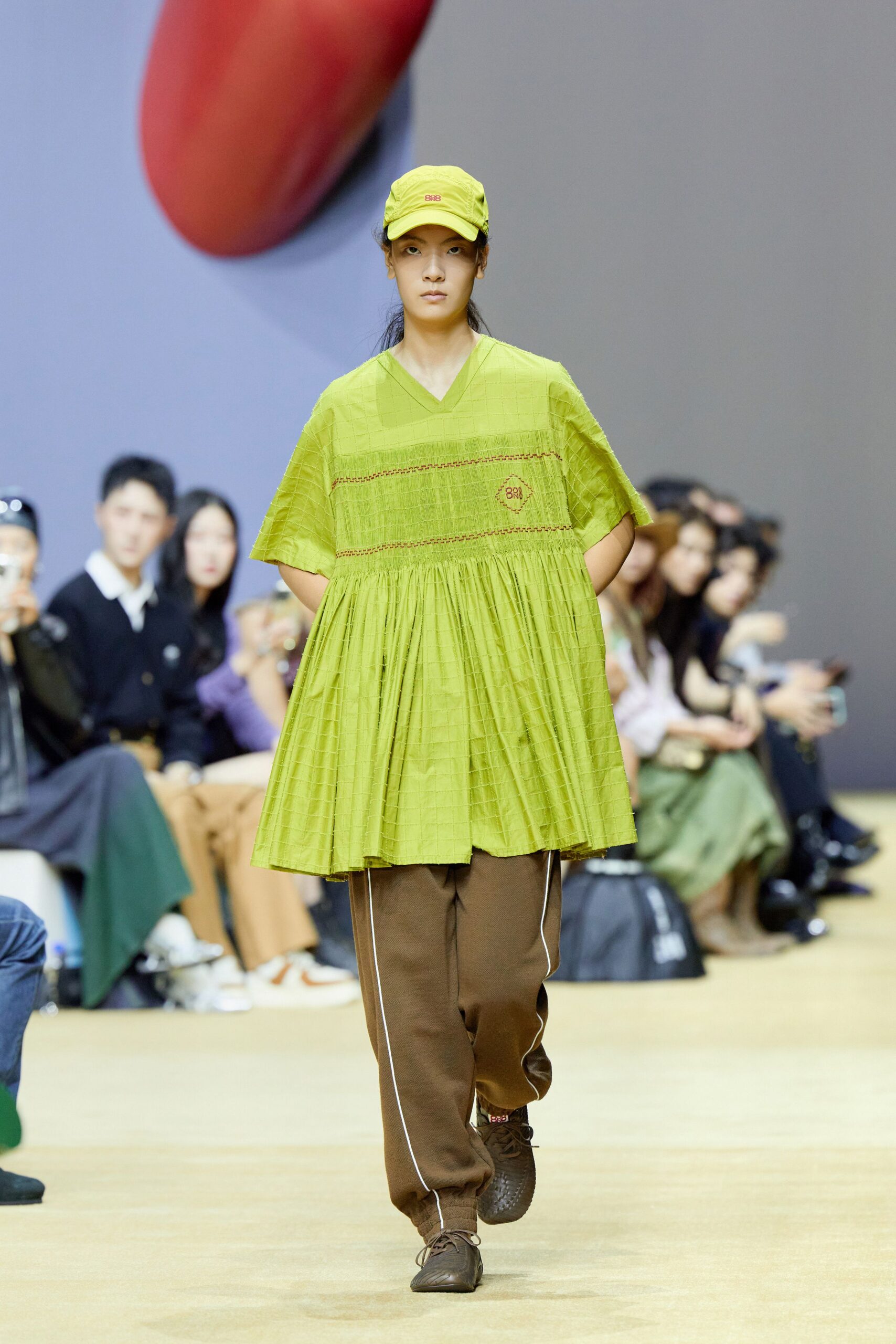 green relaxed top with brown pants