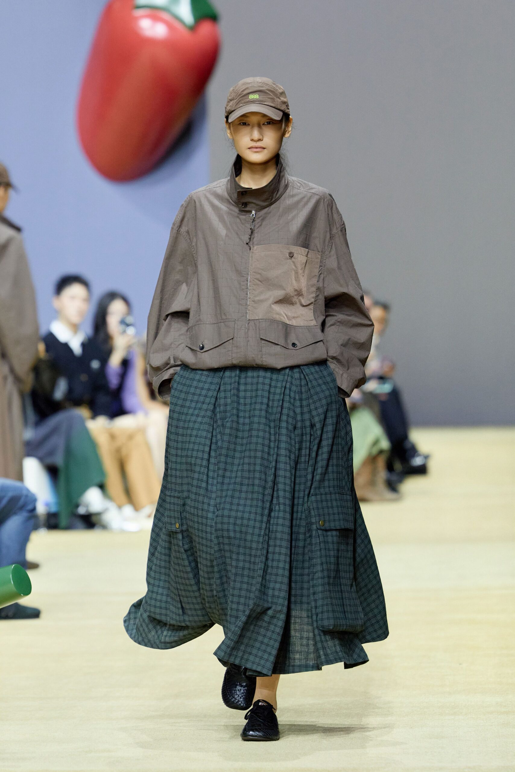 brown relaxed jacket with green pleated skirt