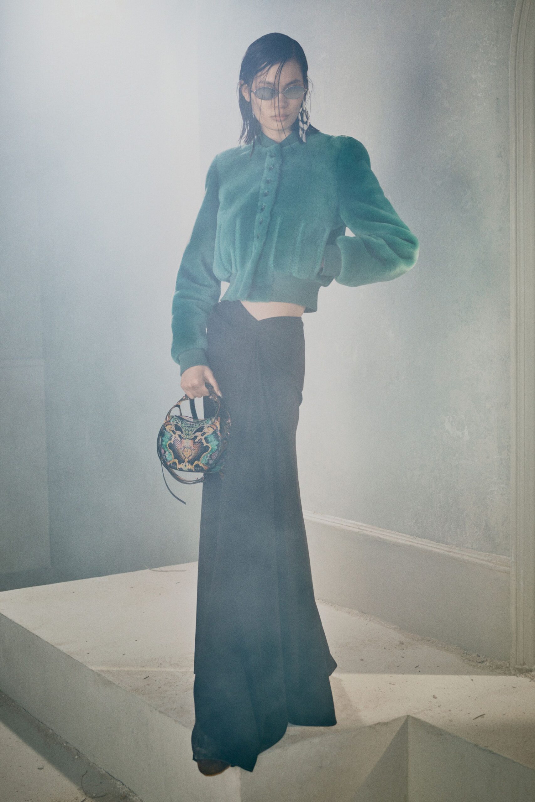 teal faux-fur jacket and black skirt