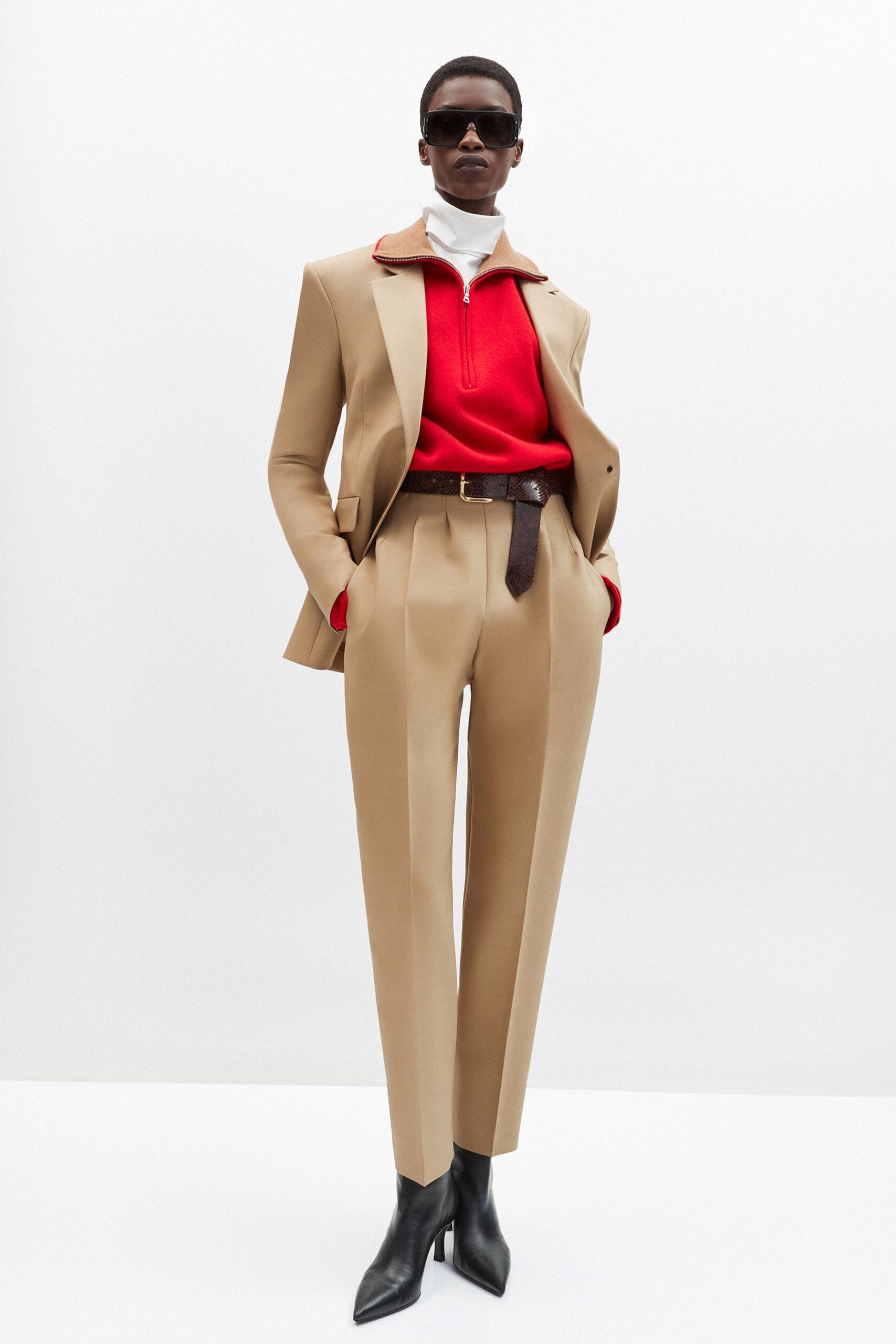 beige tailored blazer with red sweater