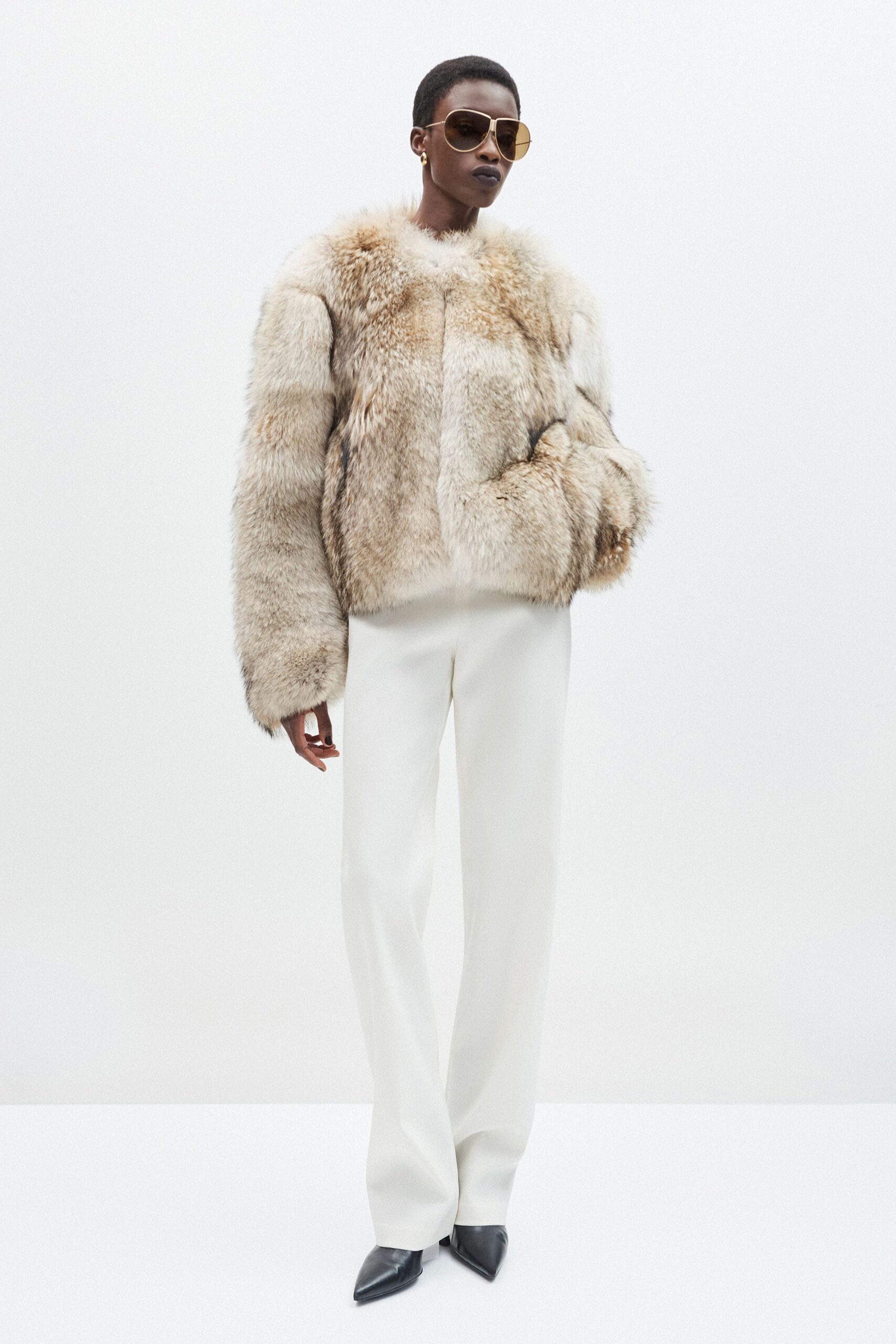 beige fur coat with white pants