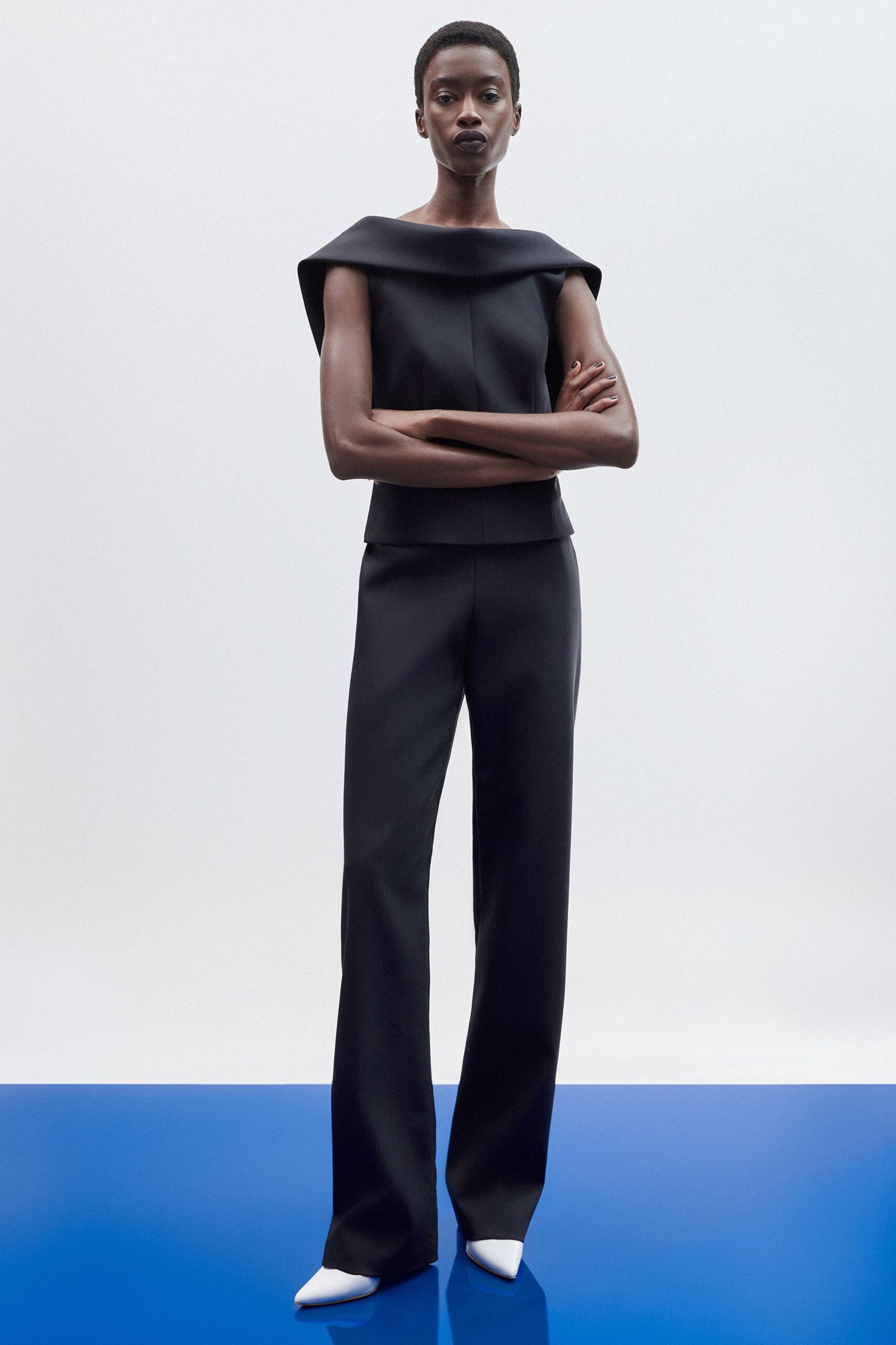 black cotton sleeveless high-neck fitted structured top
