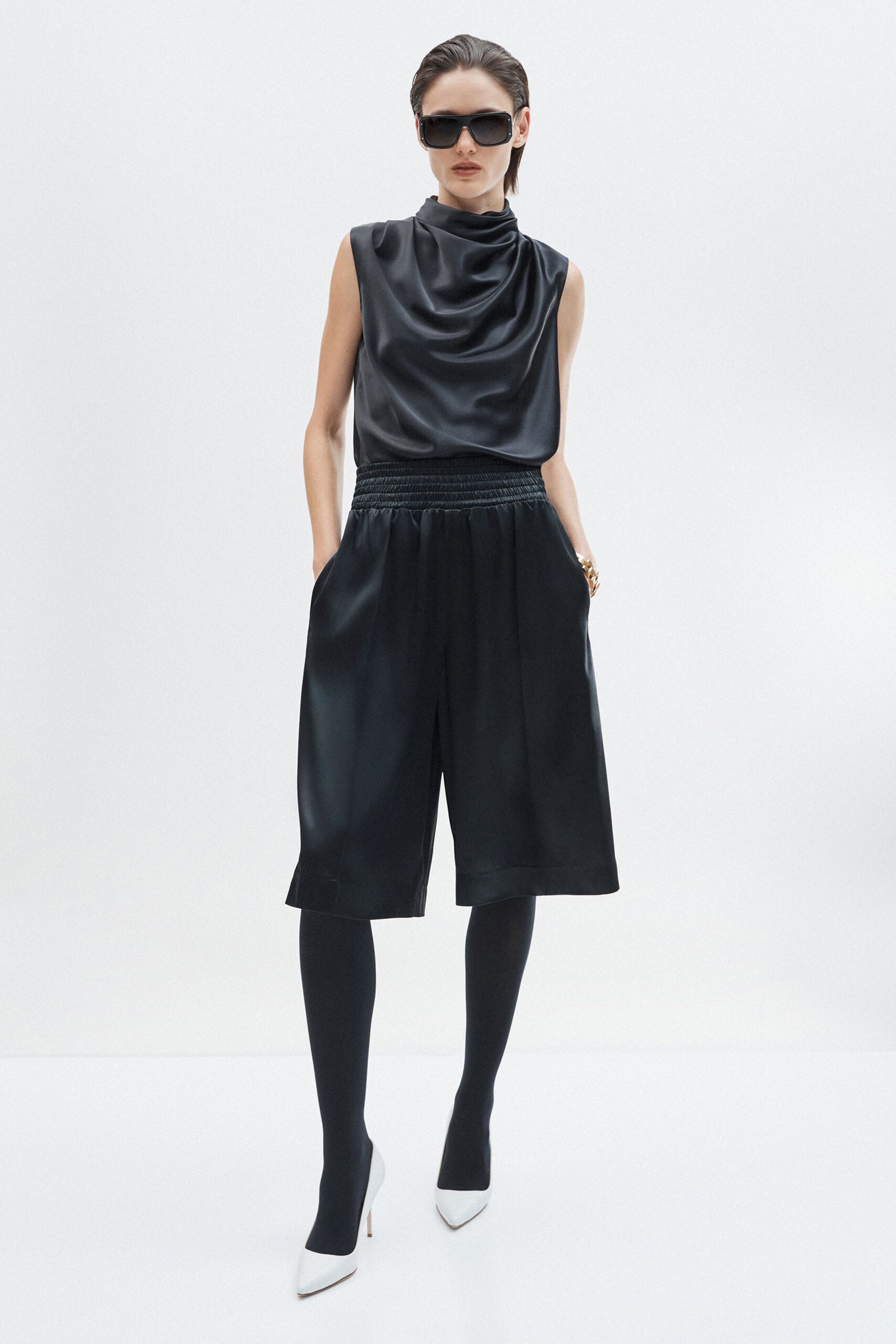 black silk sleeveless high-neck fitted draped top