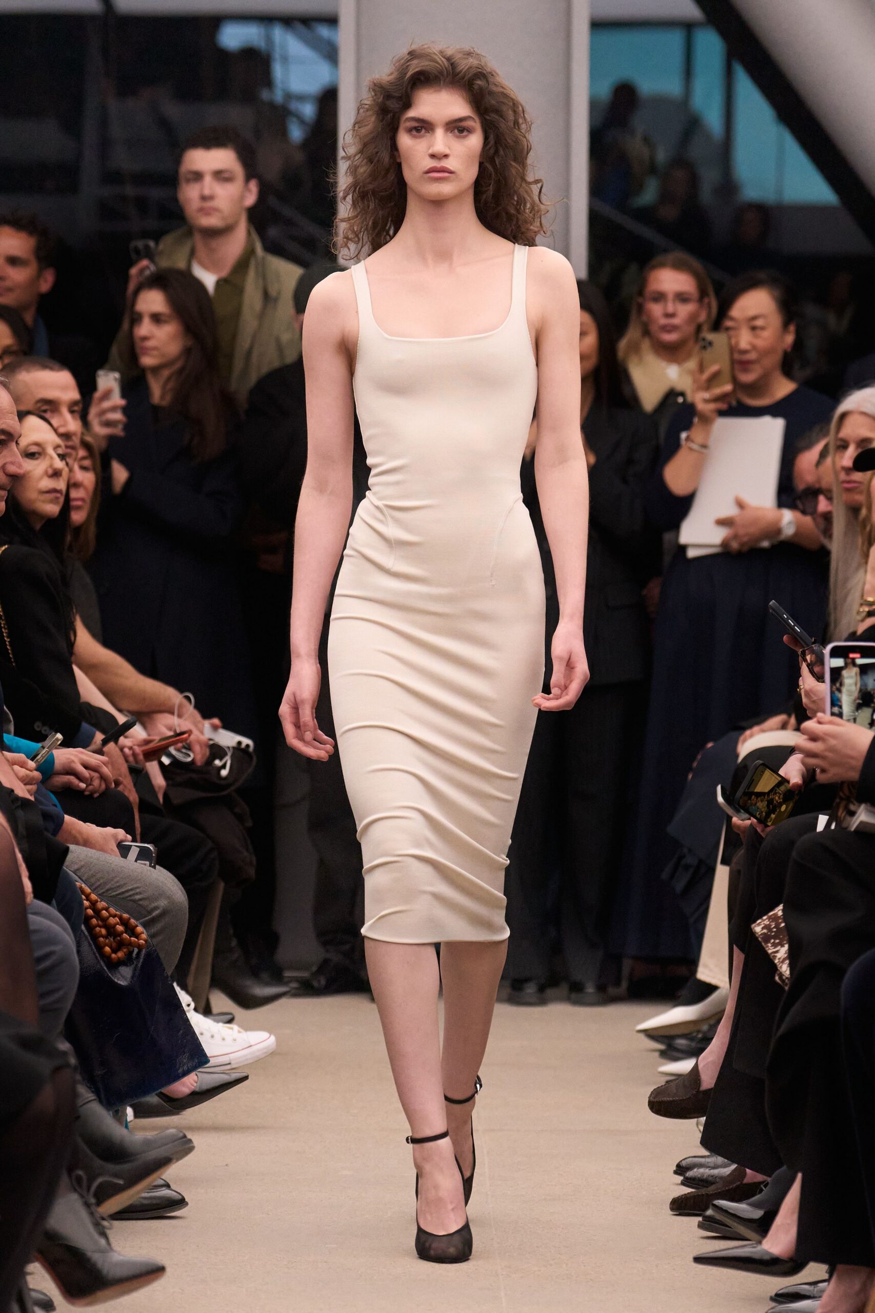 beige fitted midi dress with black shoes