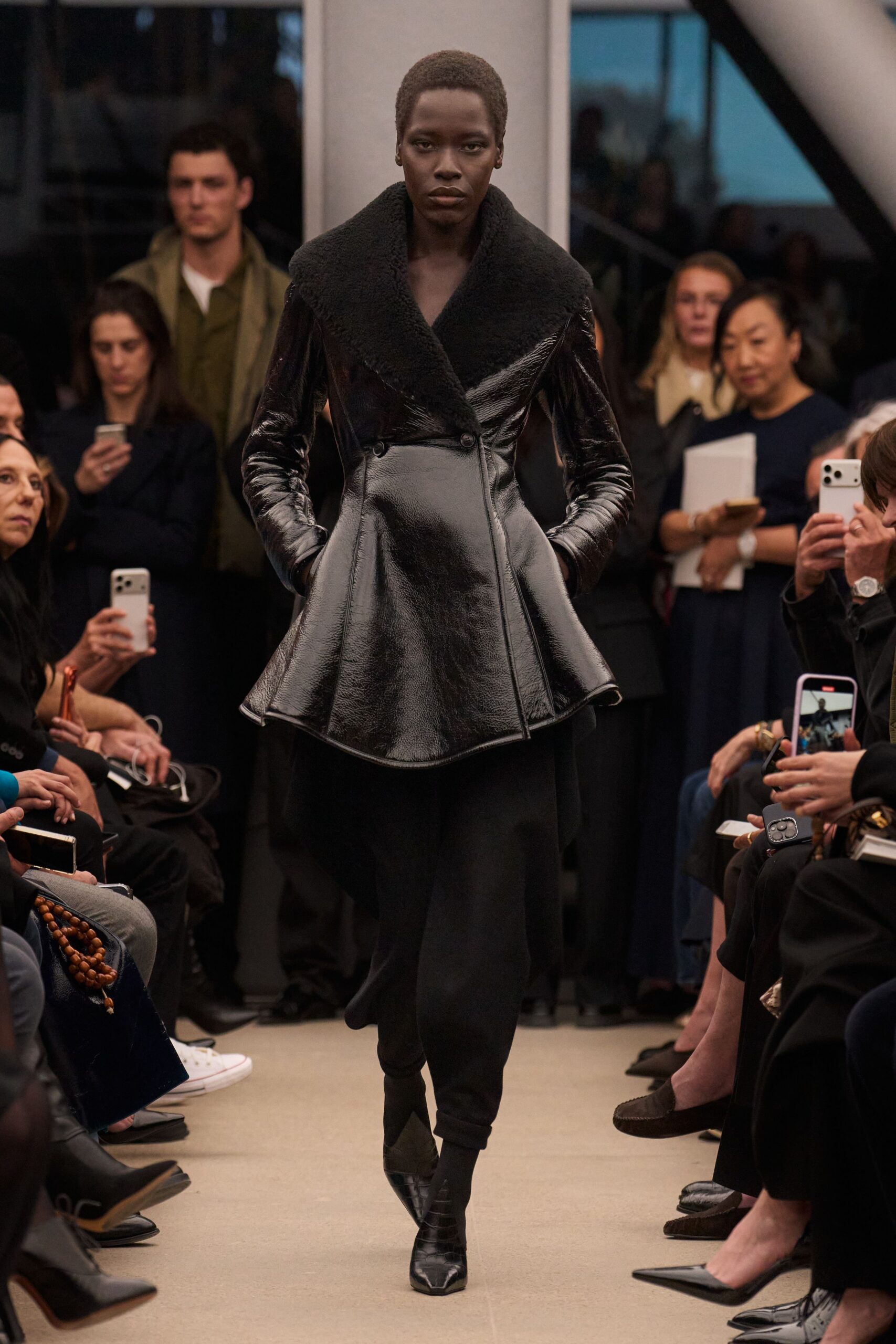 black leather long-sleeve collared fitted zippered shiny coat