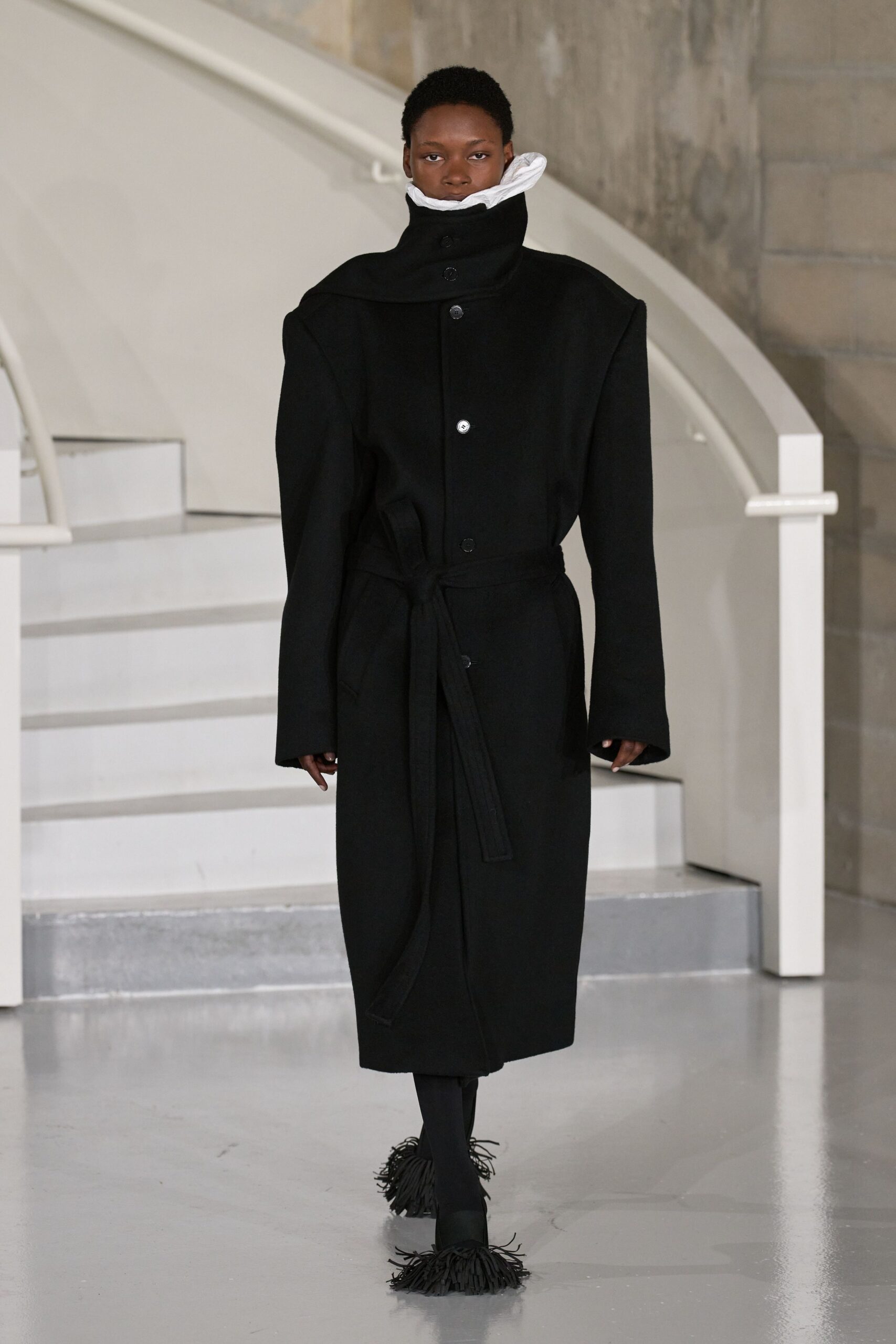 black wool coat with fringed shoes