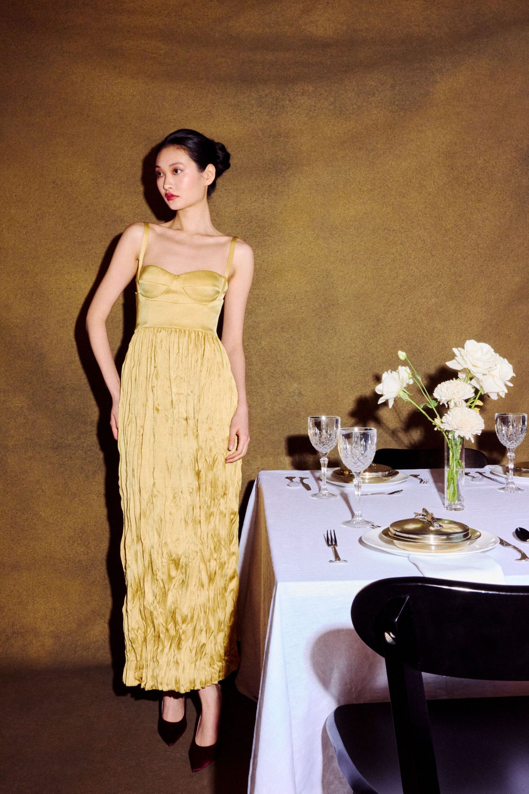 yellow silk sleeveless v-neck fitted pleated flowing gown