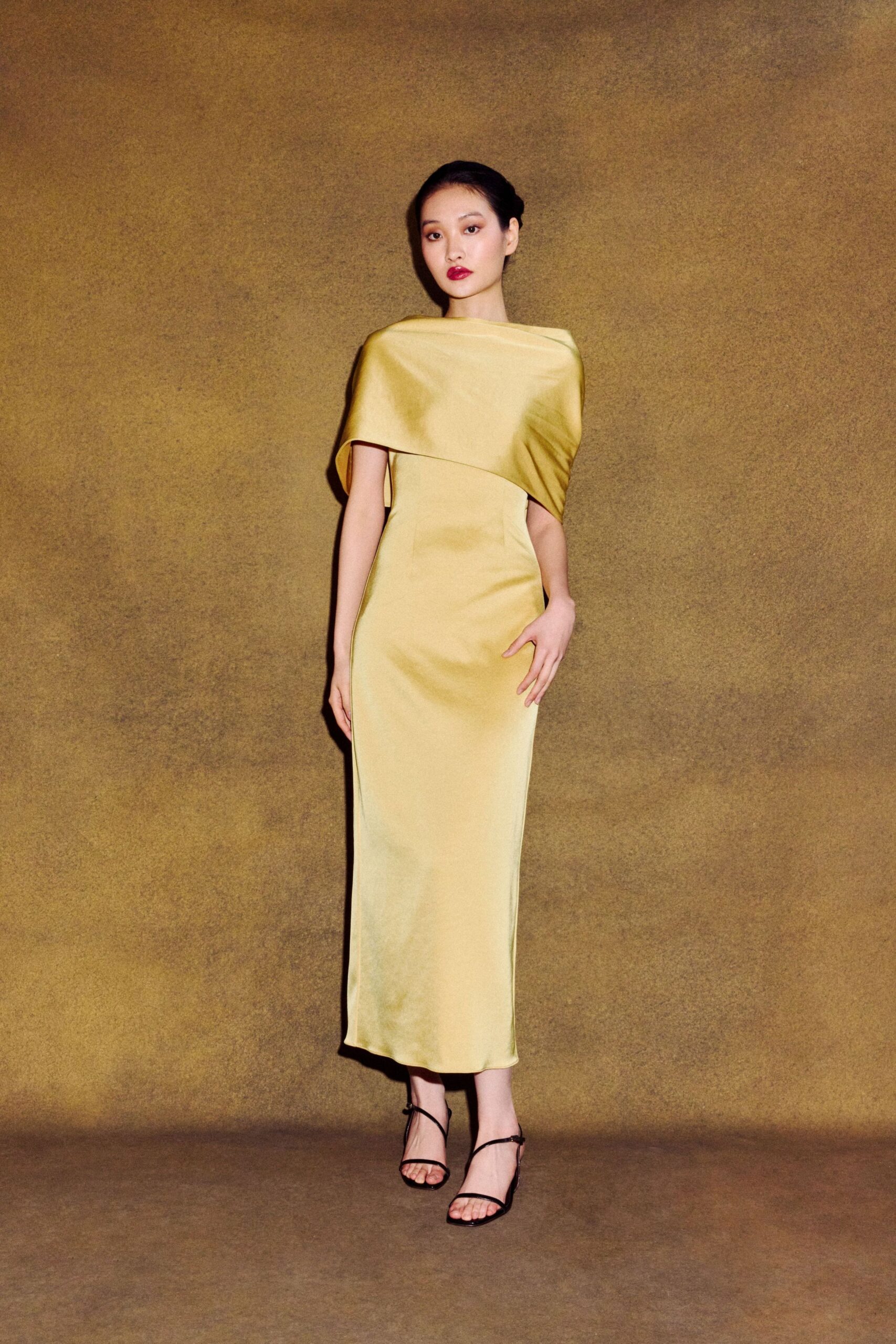 yellow silk sleeveless high-neck fitted draped flowing gown