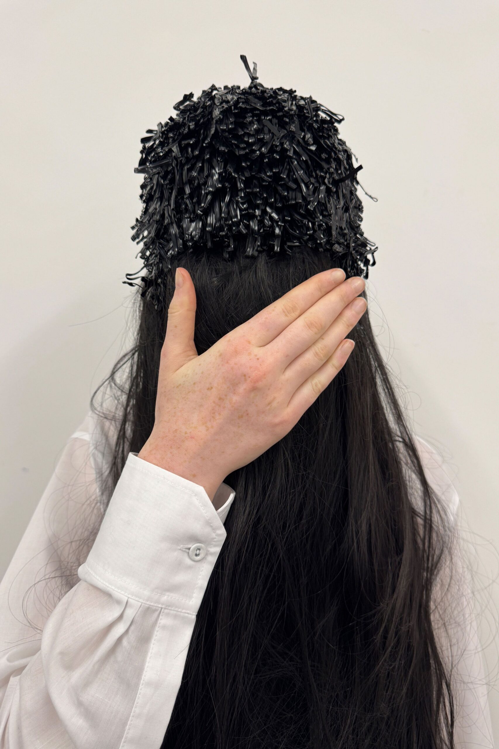 white relaxed shirt with black textured hat