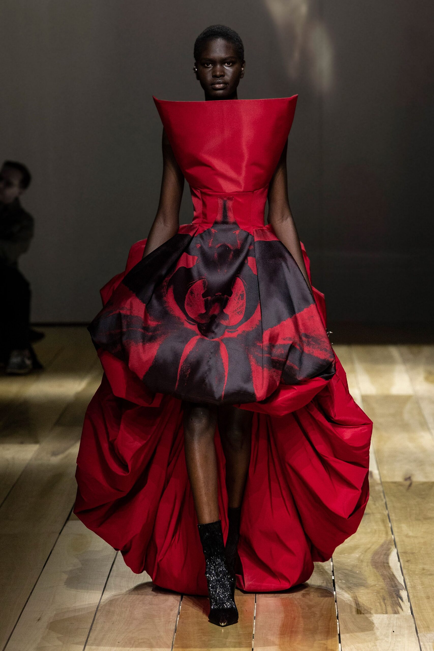 red silk sleeveless high-neck fitted pleated flared gown