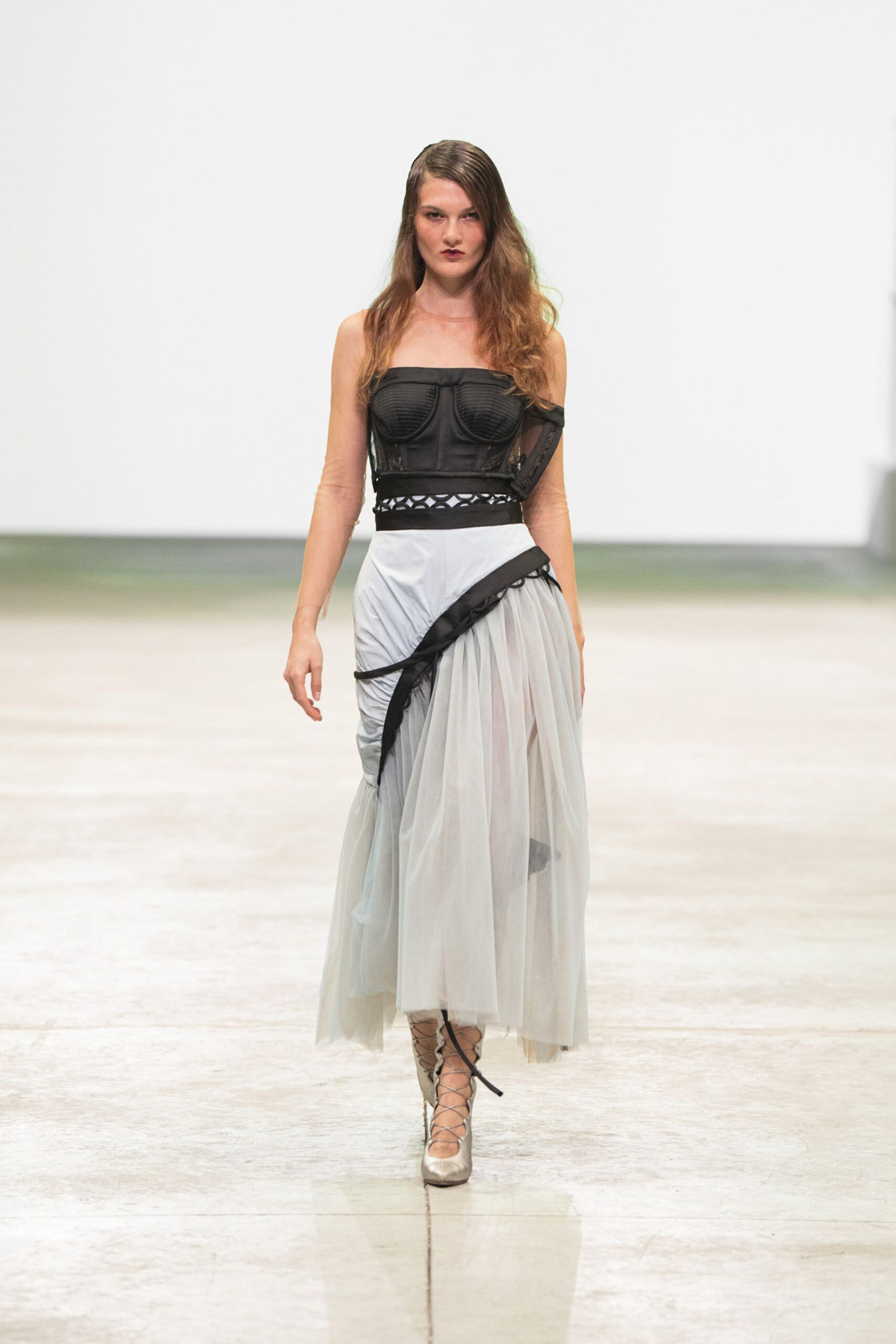 black tulle strapless fitted draped pleated flowing gown