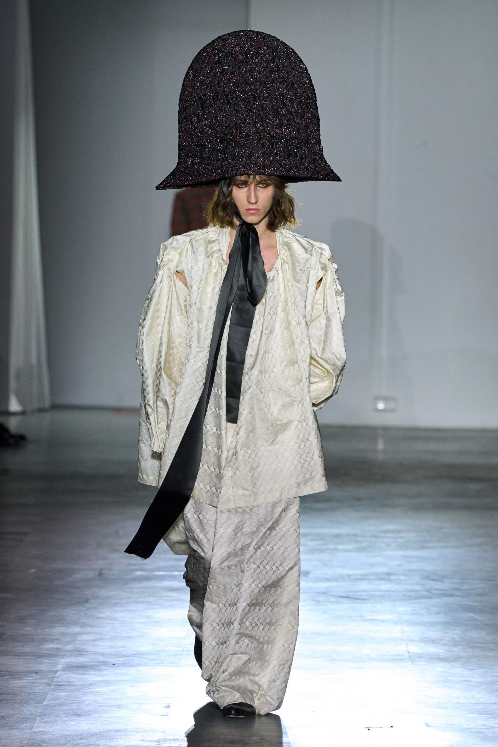 white quilted coat with black hat