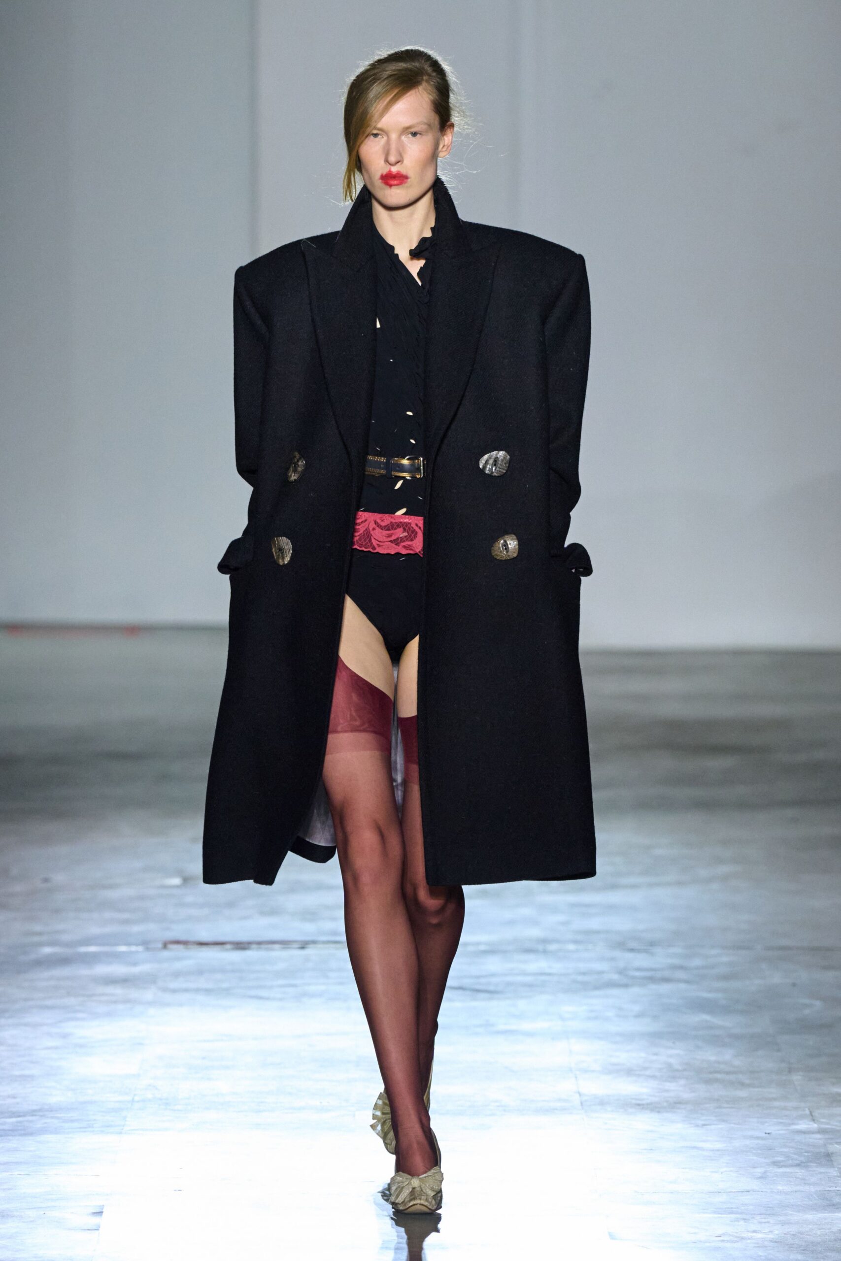 oversized black coat with fitted shirt and shorts