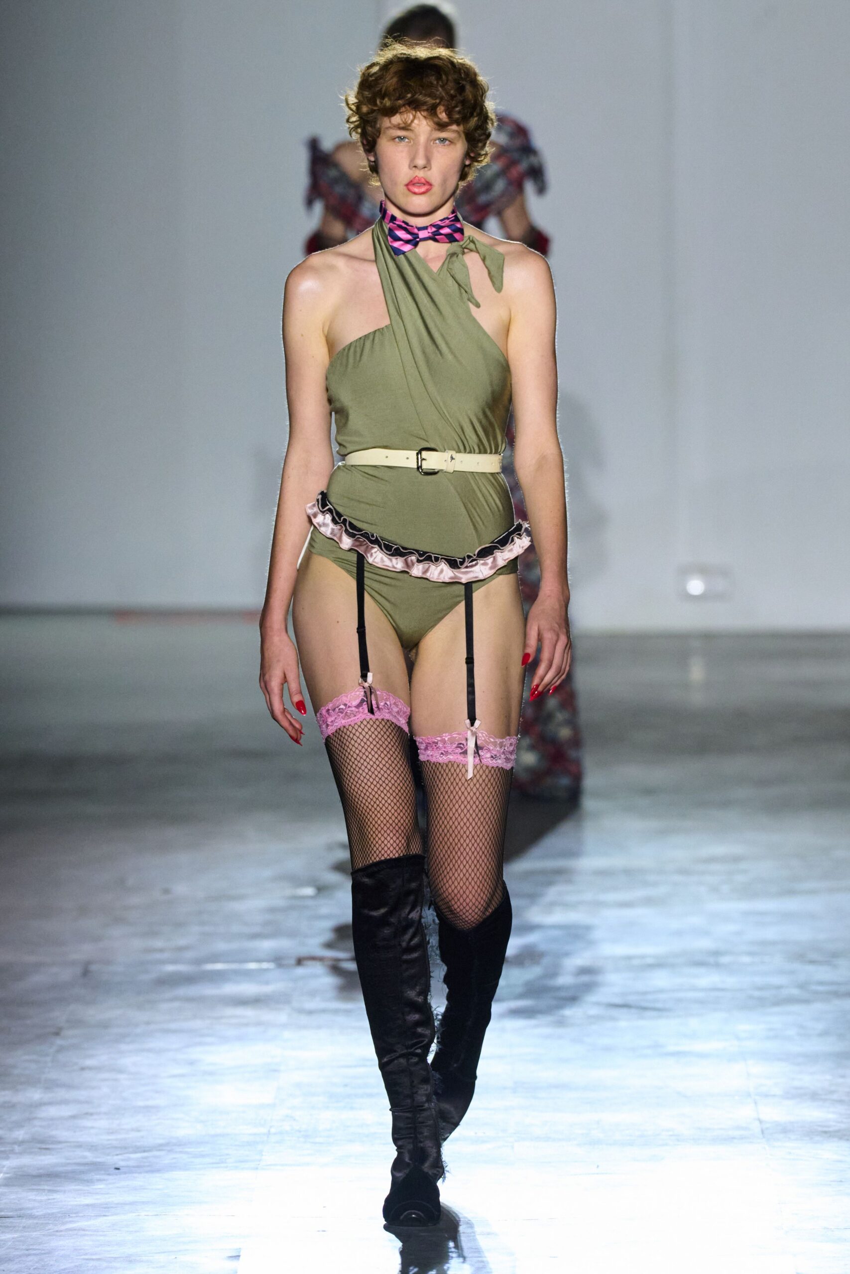 green fitted bodysuit with black boots