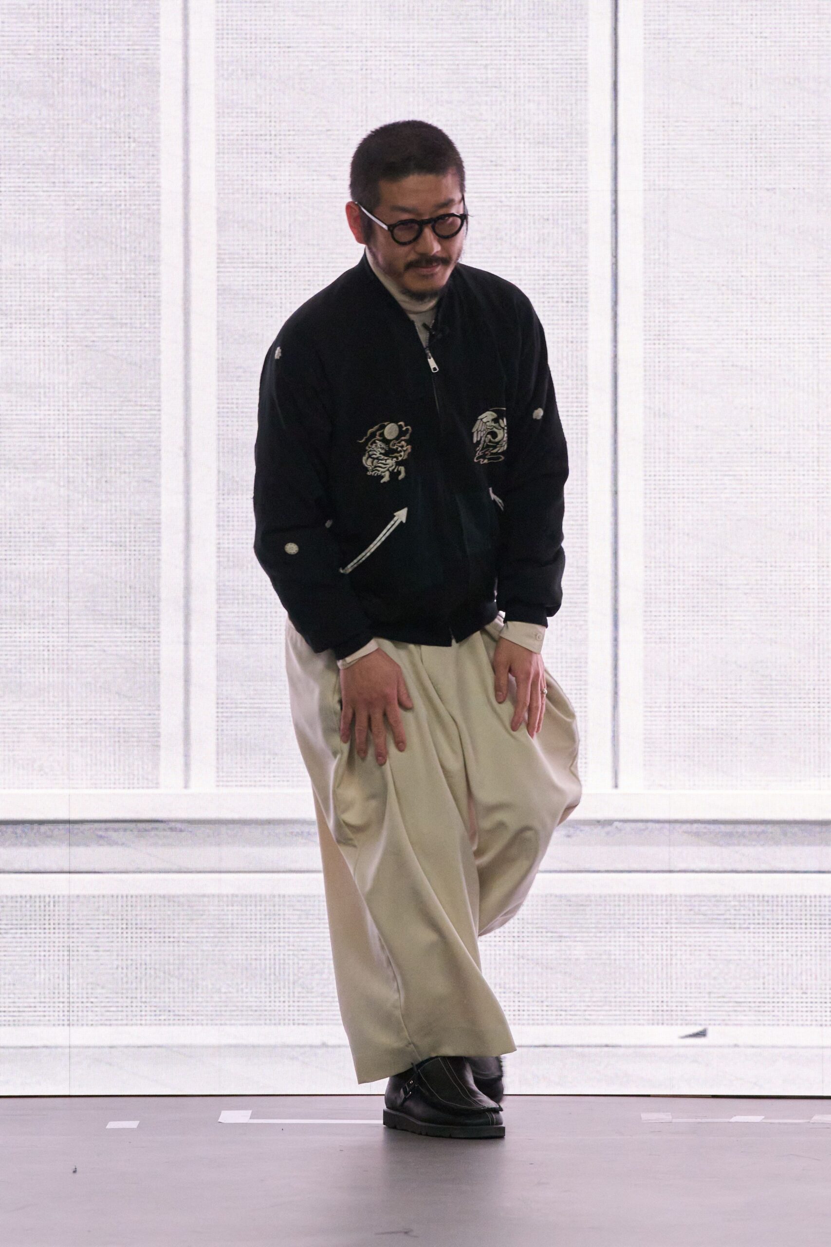 black embroidered jacket beige pants