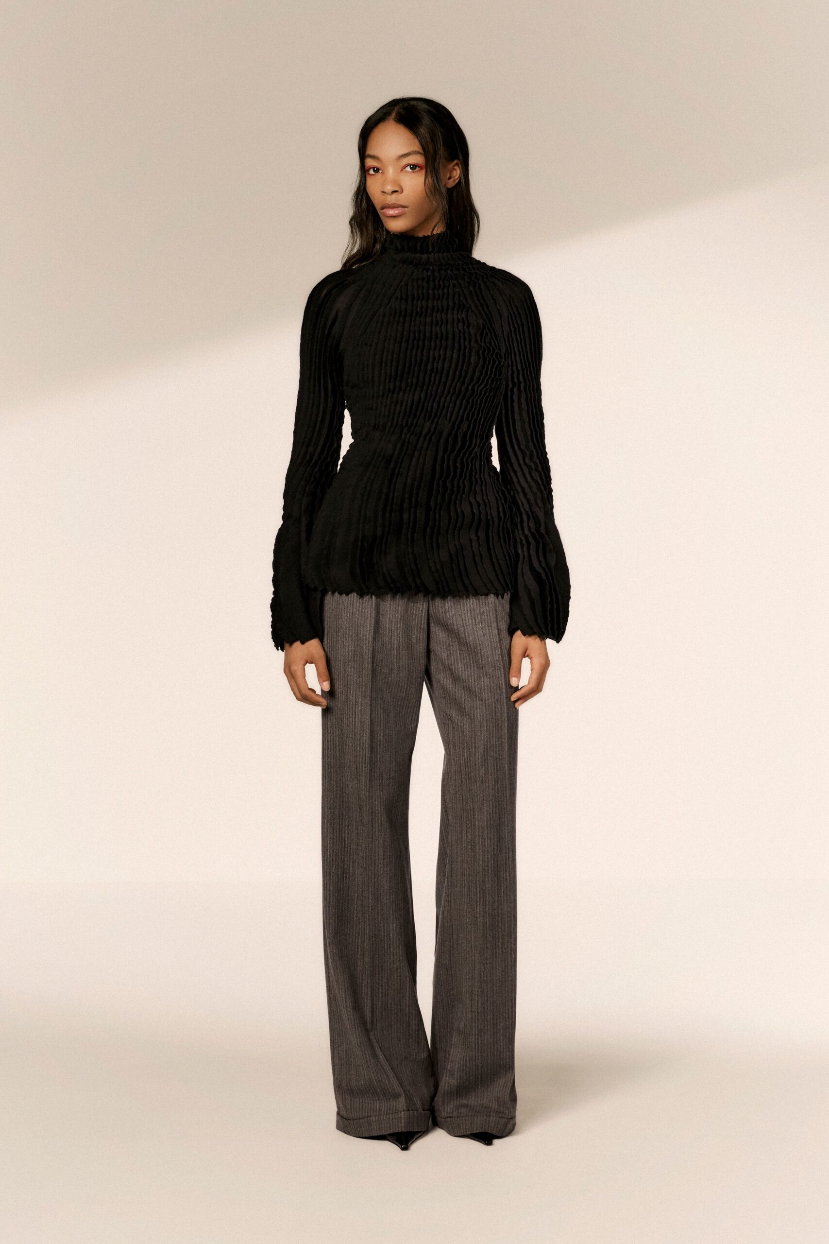 black pleated top with gray pants