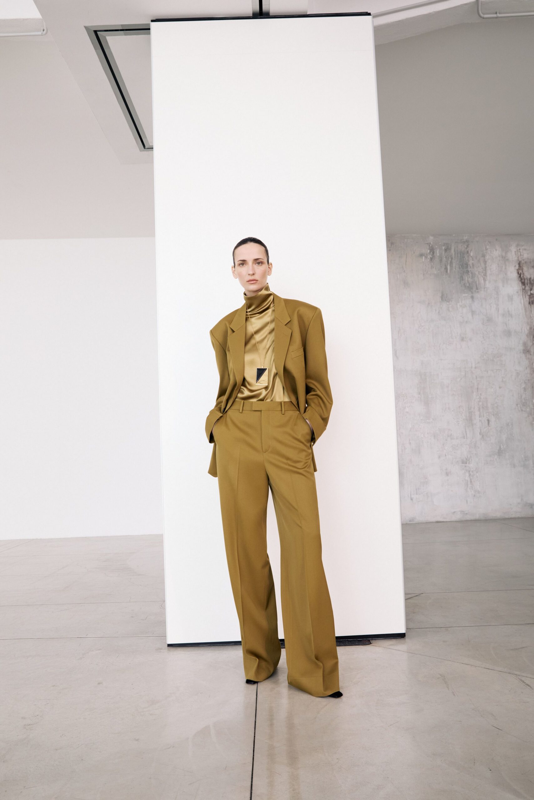 brown tailored suit with gold top