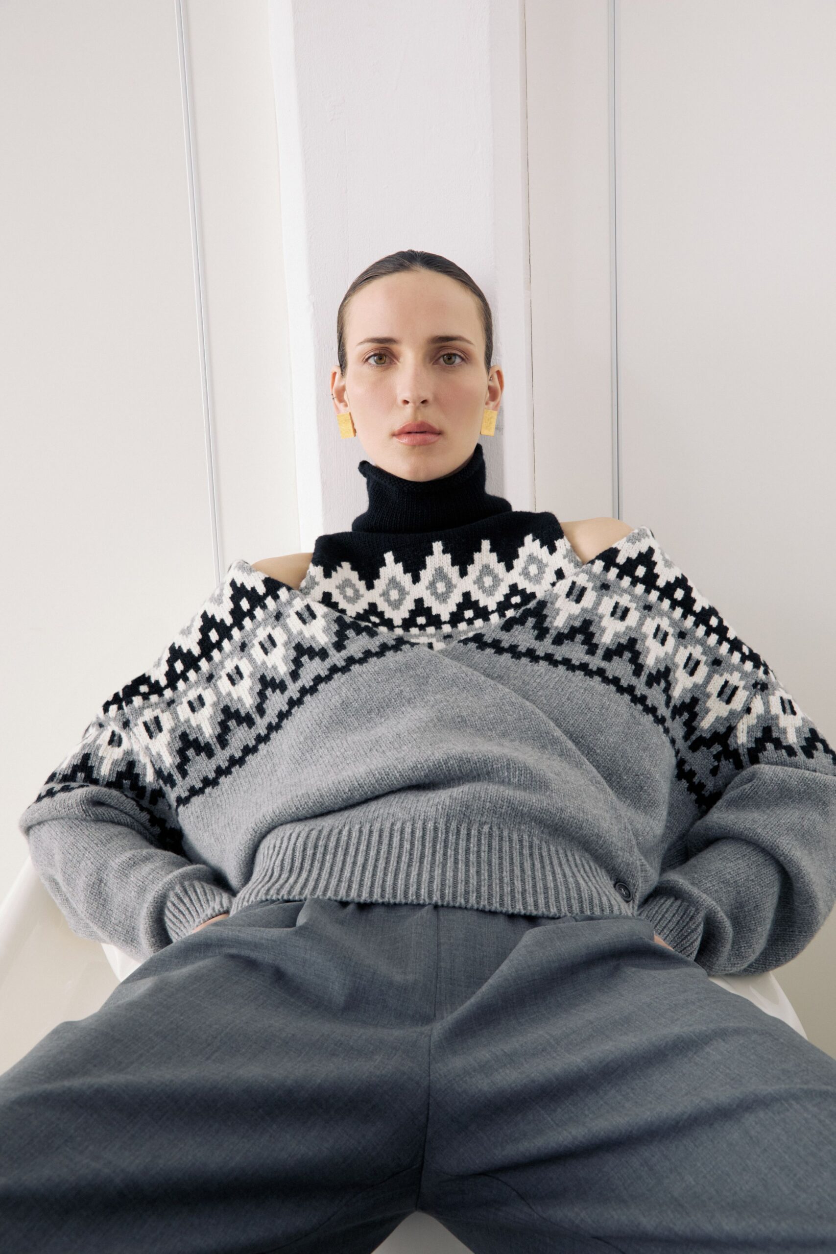 gray embroidered sweater with blue pants