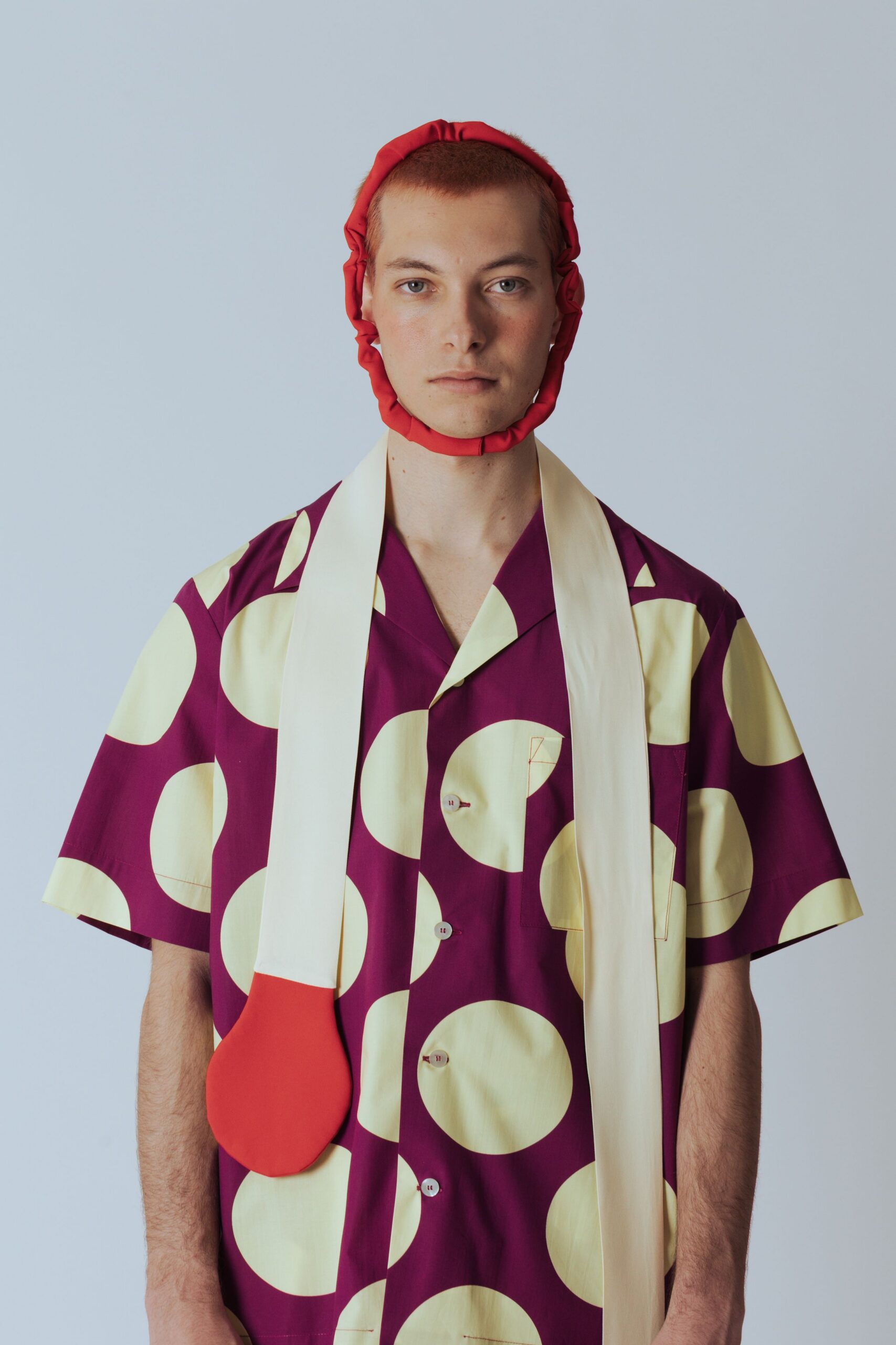 purple and yellow printed shirt with red accessories