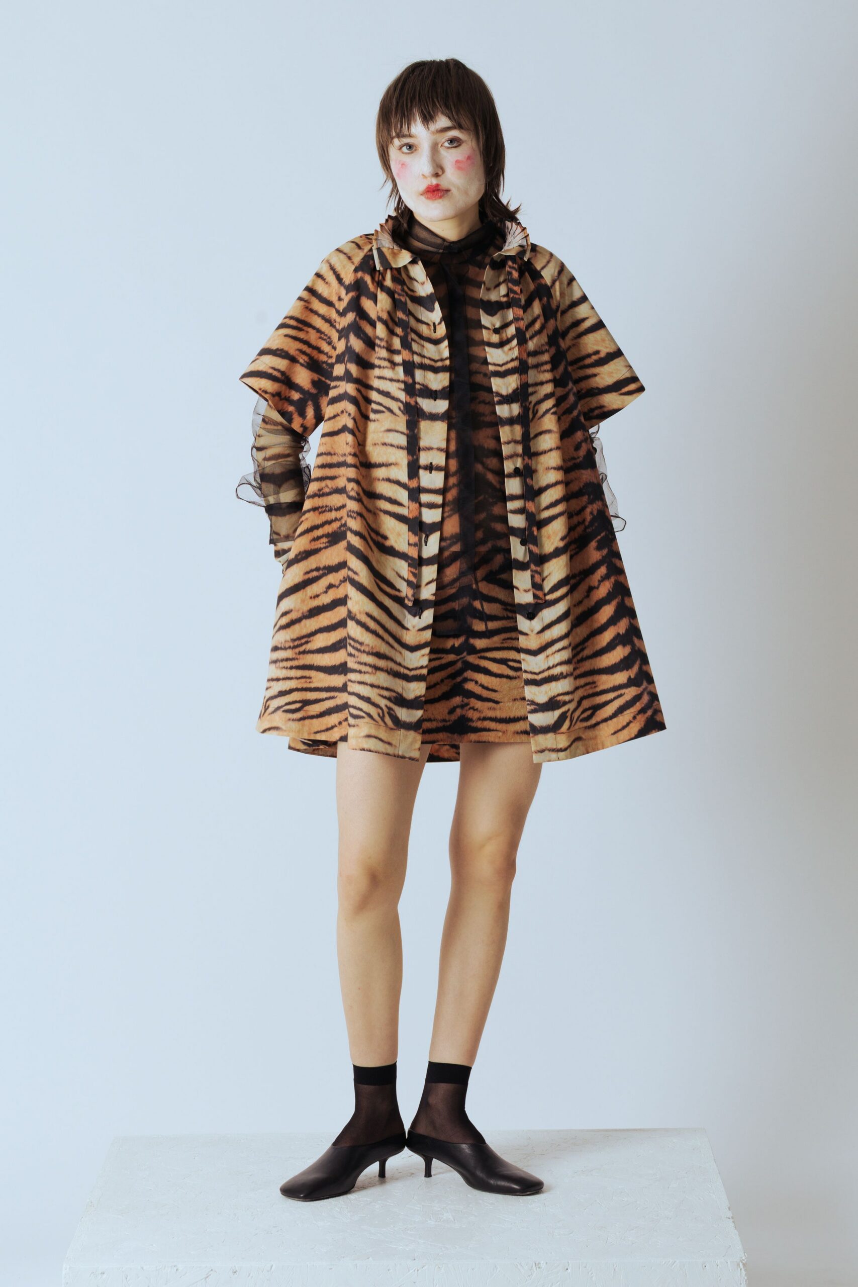 animal-print mini dress and black shoes
