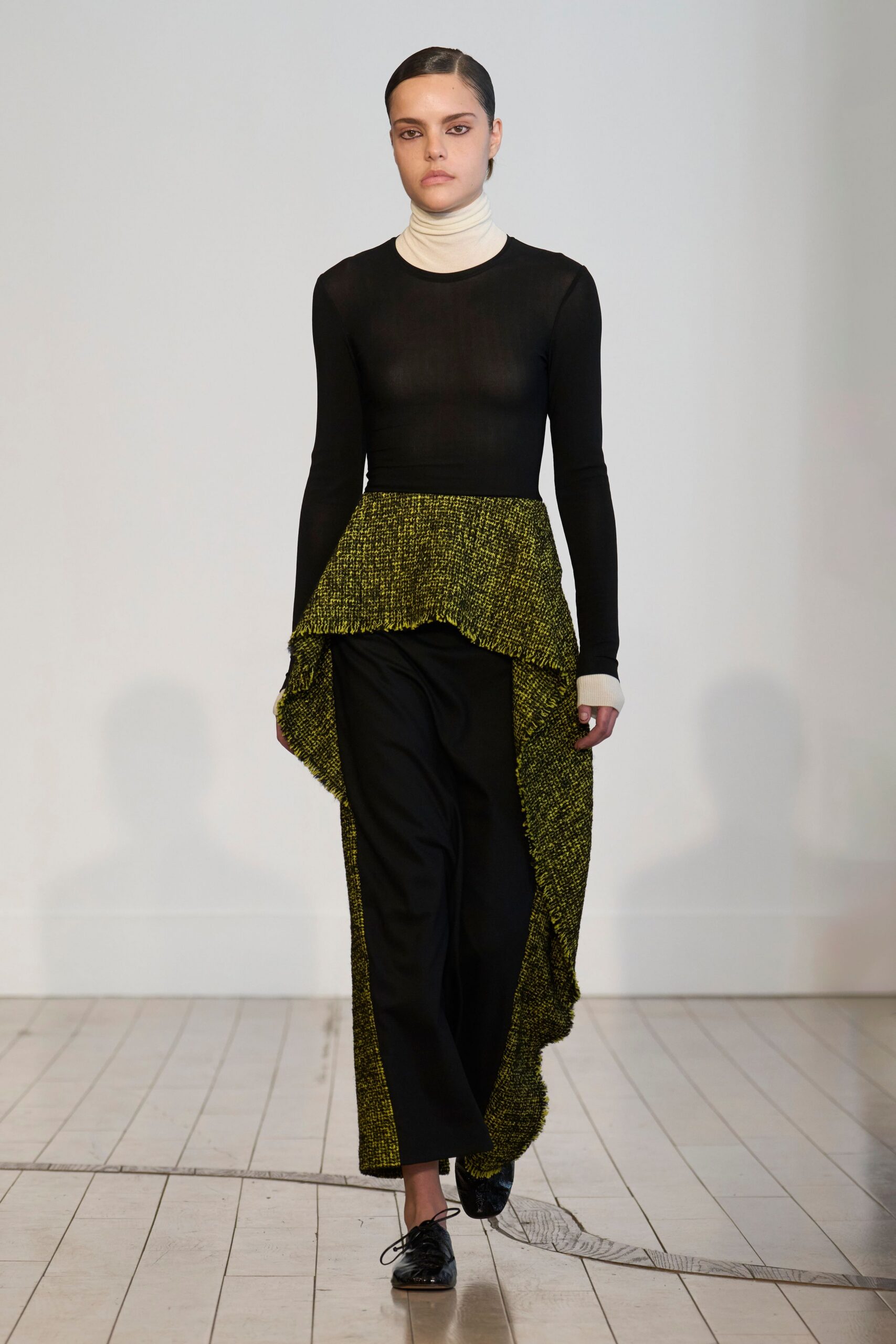 black fitted top with green asymmetric skirt