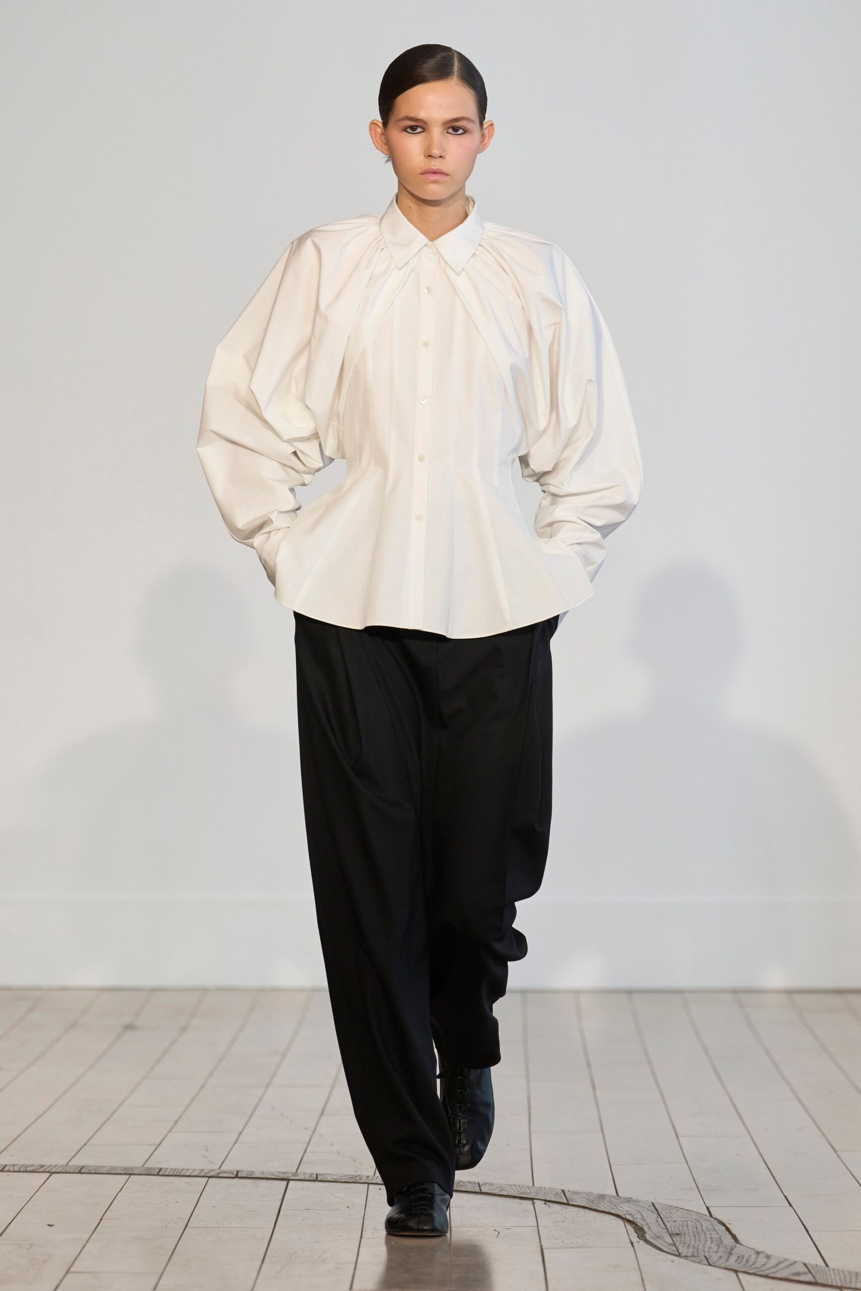 white relaxed shirt with black pants