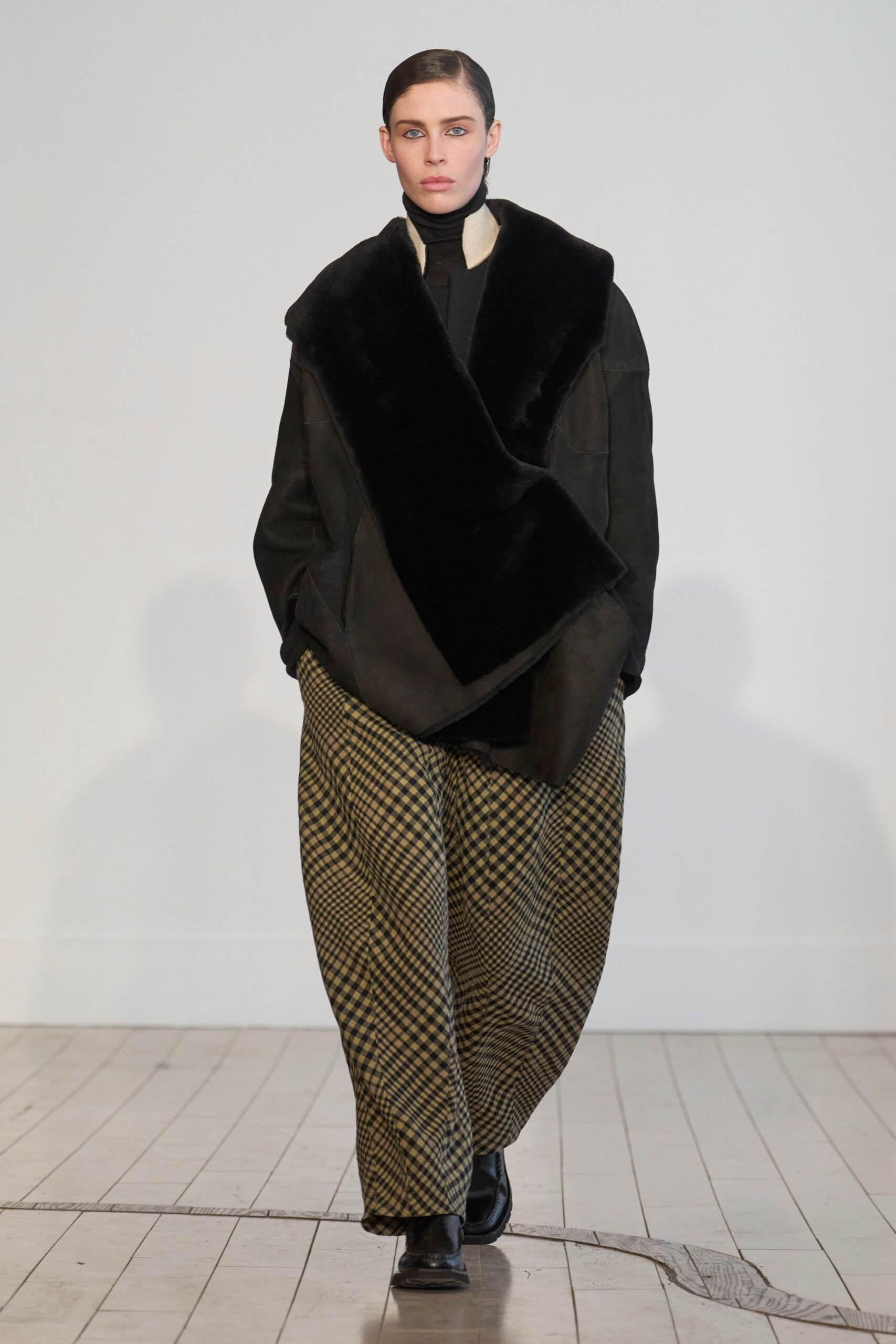 black faux-fur jacket with checked pants