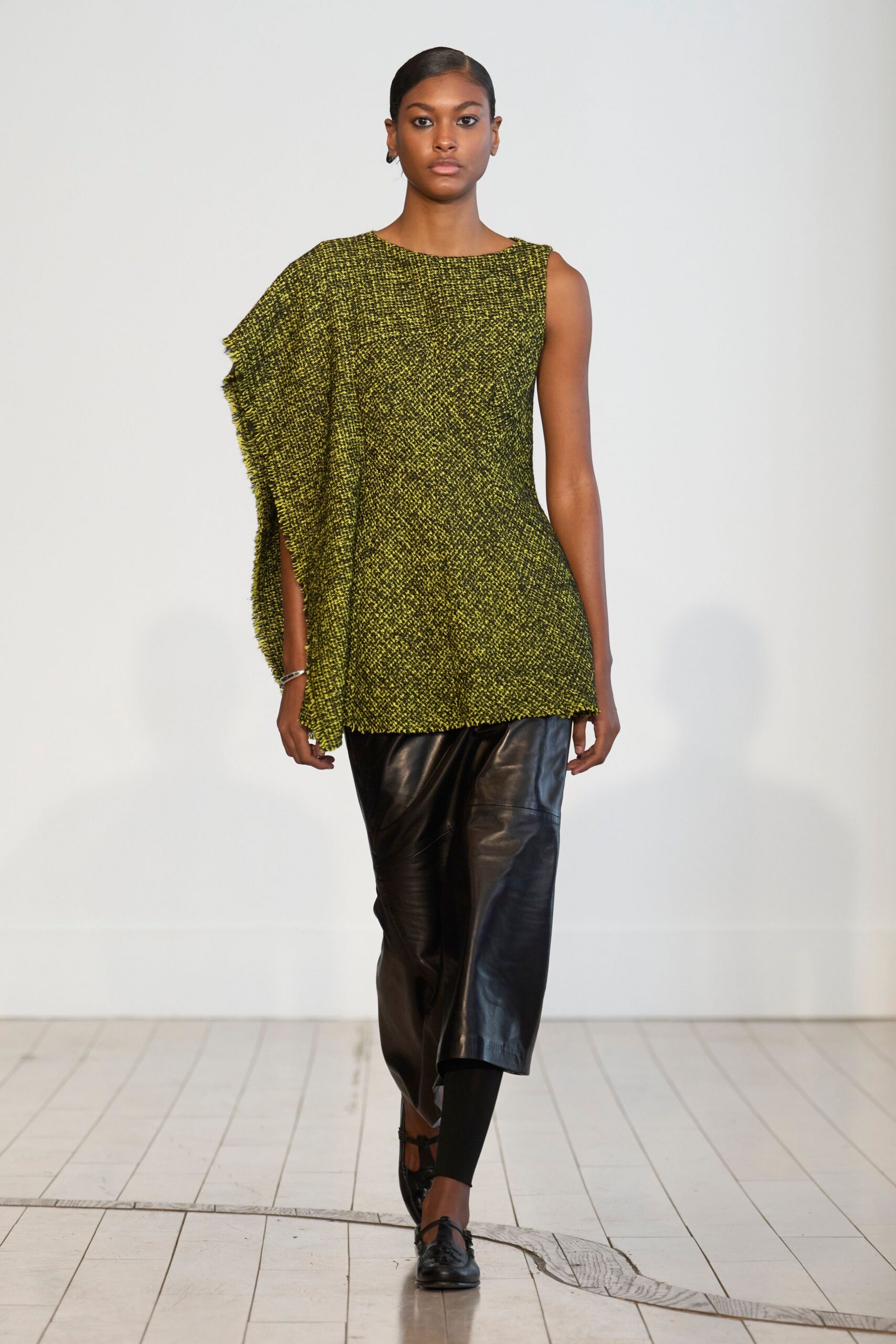 asymmetric green top with black pants