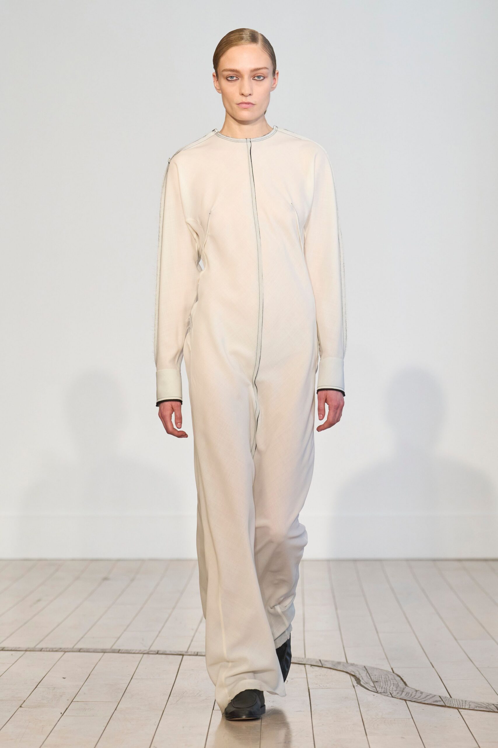 white fitted jumpsuit with black shoes