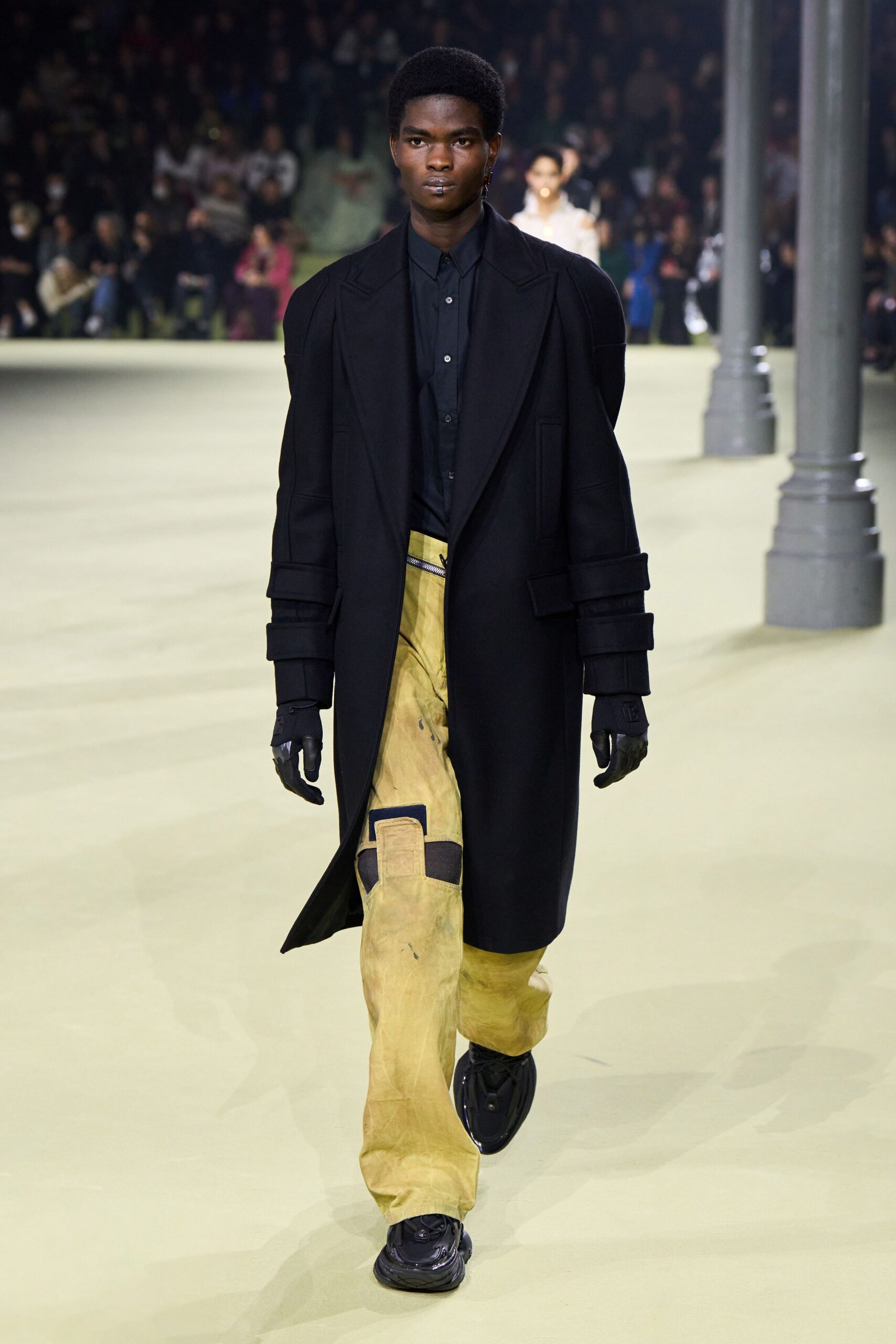 black wool coat with yellow pants